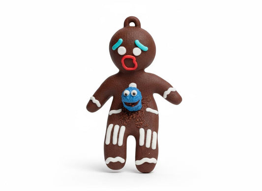 Close-up of gingerbread chestburster figurine showing cookie crumb details and frightened expression