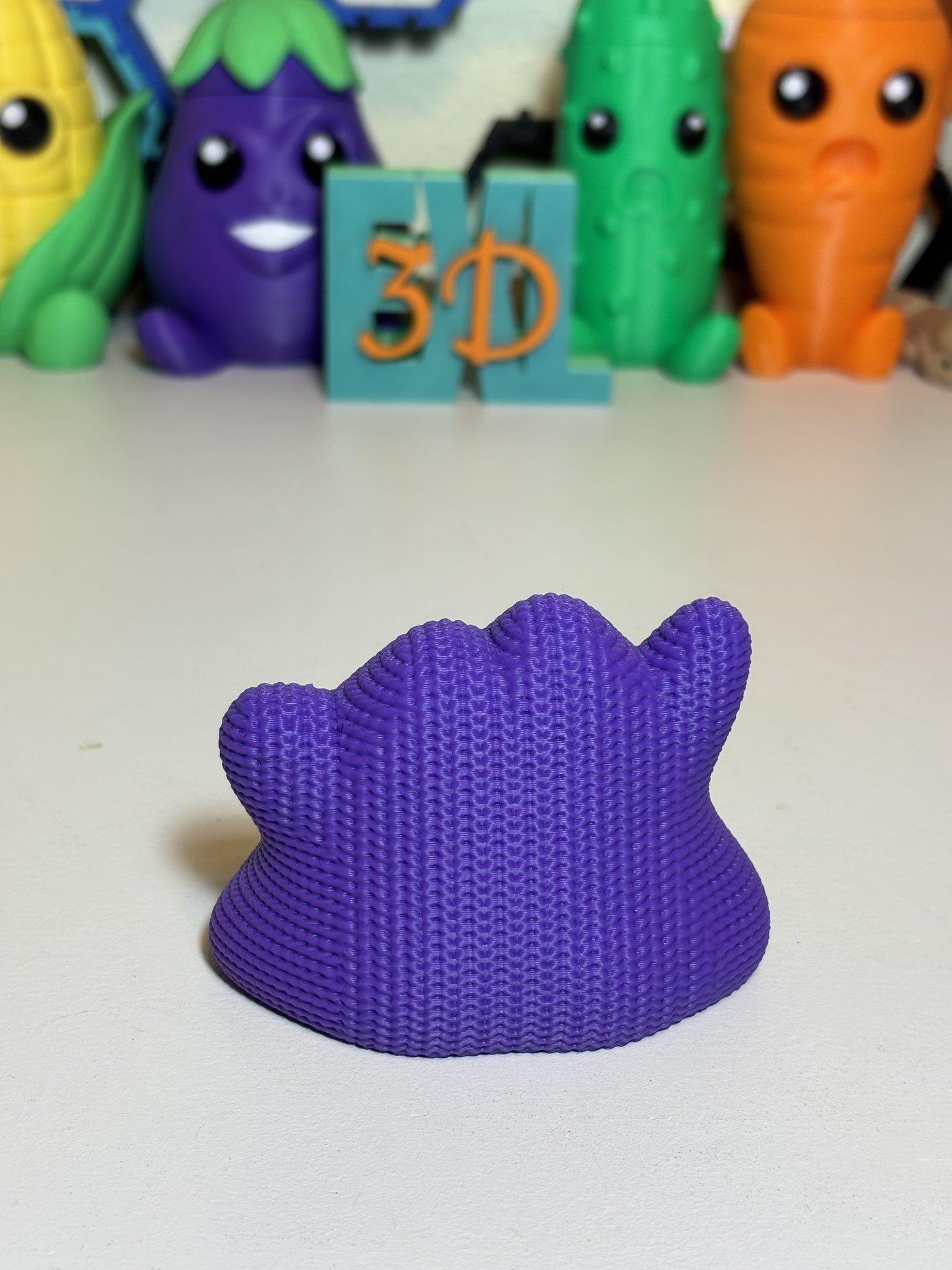 Side profile of 3D printed Ditto statue highlighting knit texture detail