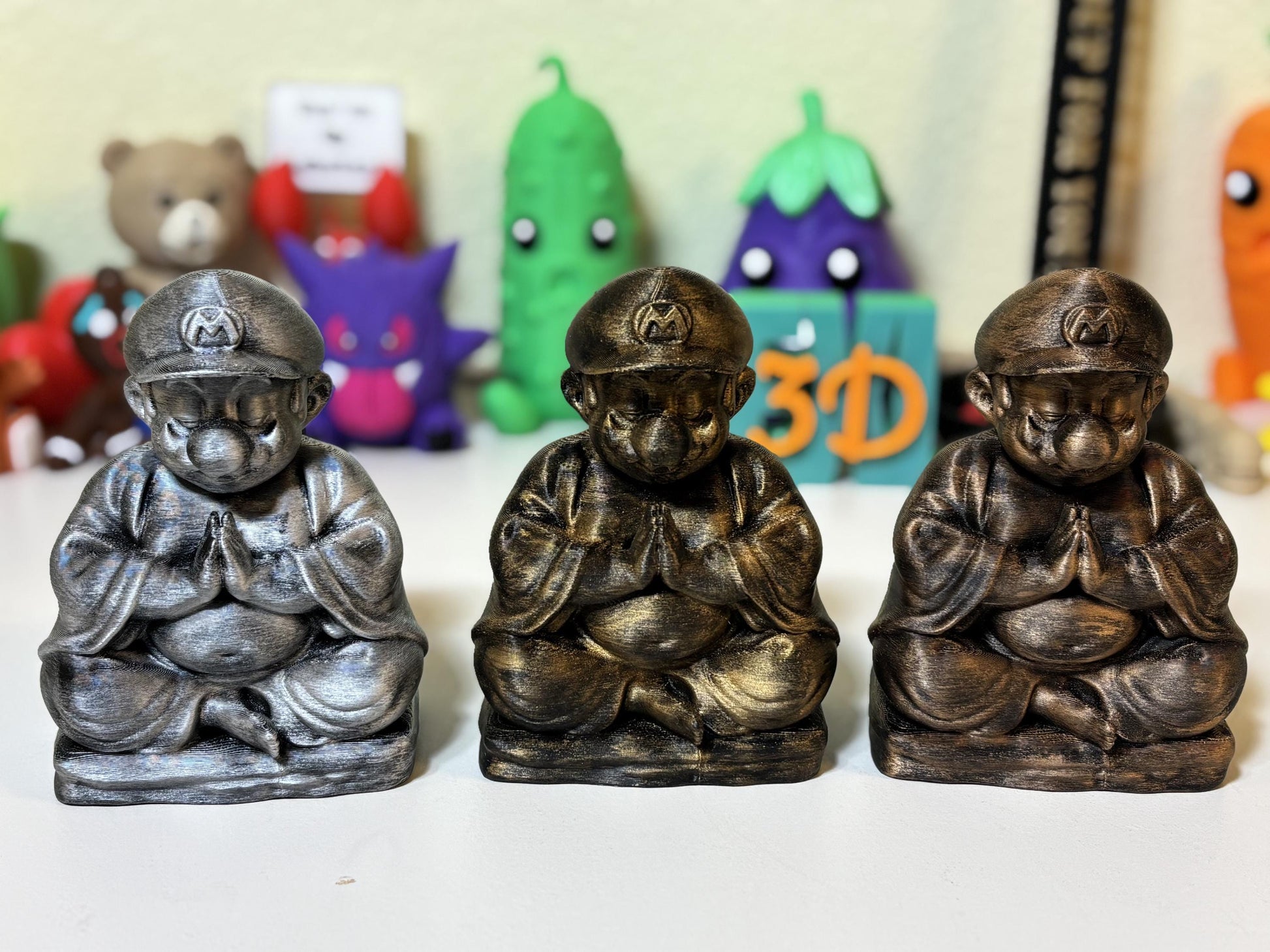 Gold metallic 3D printed Buddha plumber statue on gamer desk