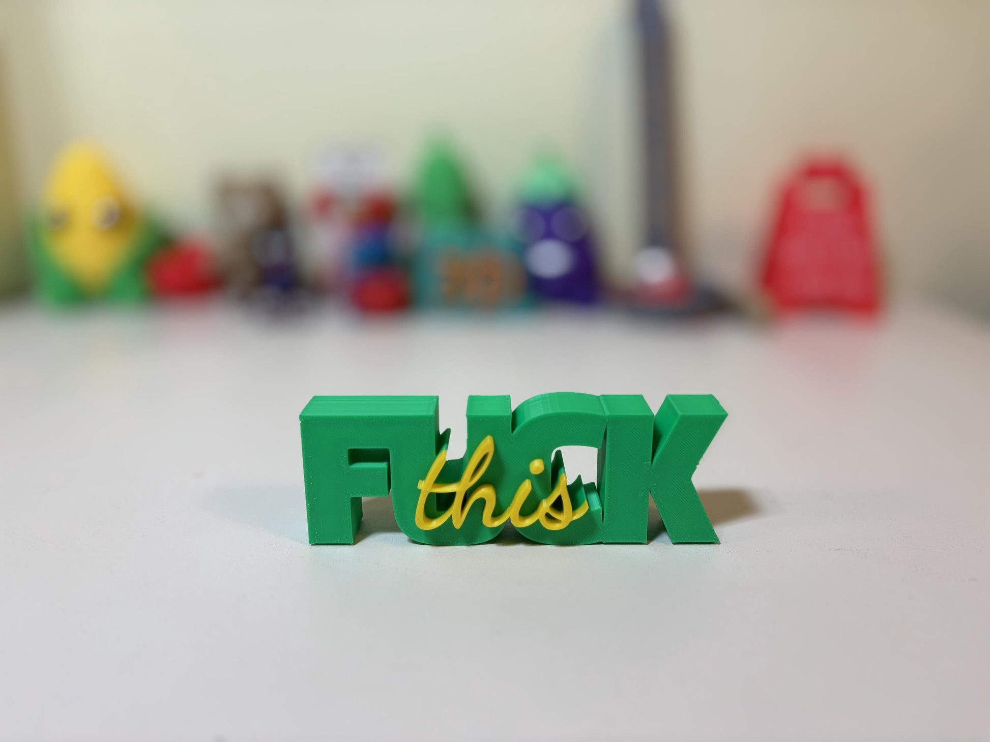 Close-up of 3D printed script layer detail on F-word sign in two colors