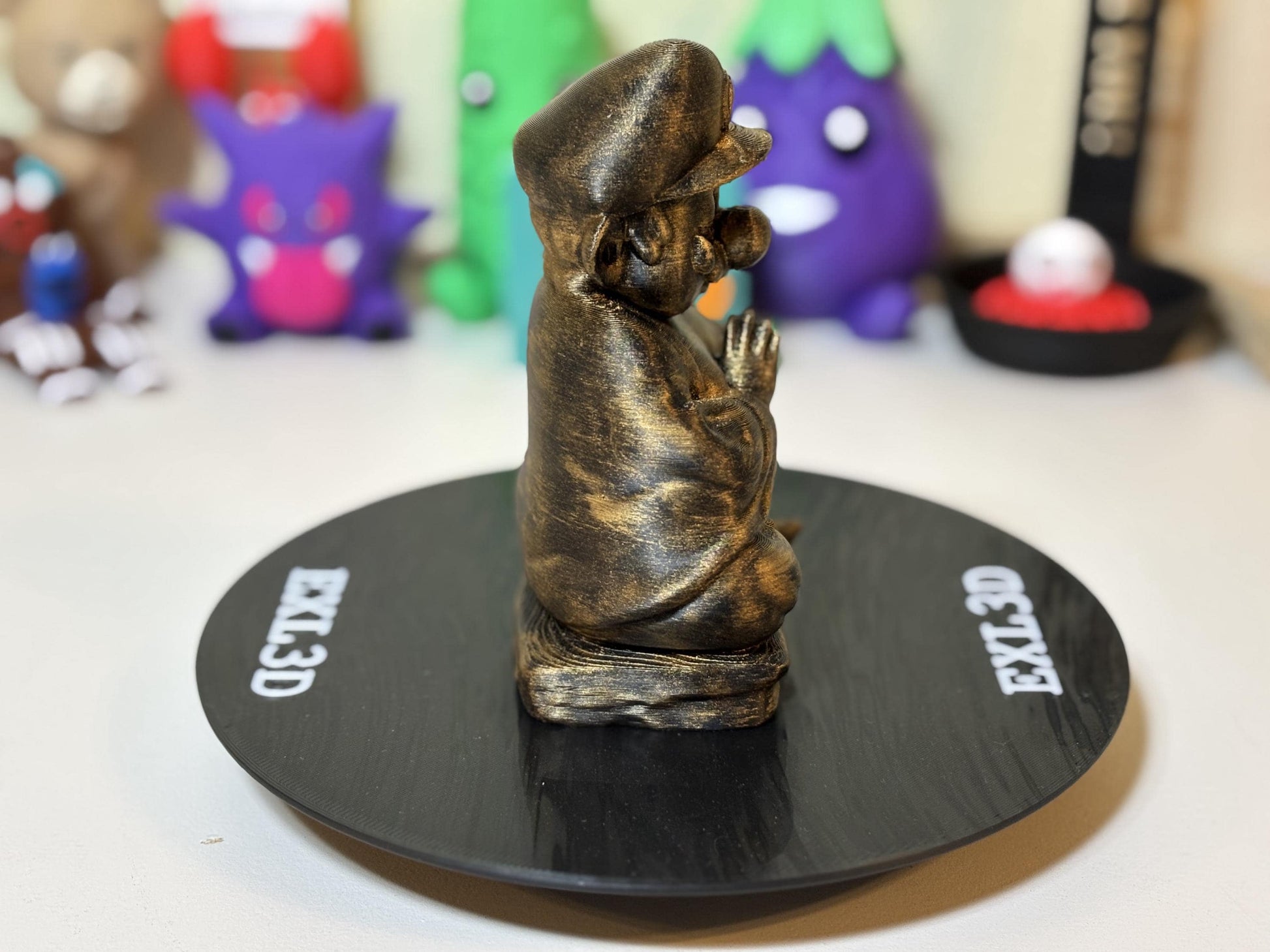 Top-down angle of silver zen statue on minimalist desk surface