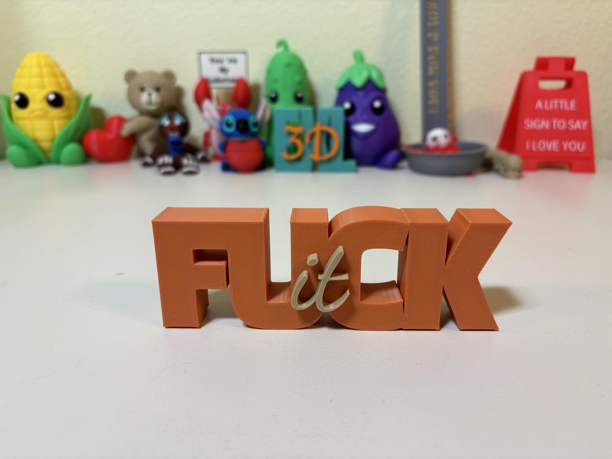 Customizable F-word sign in black colorway styled on home office desk