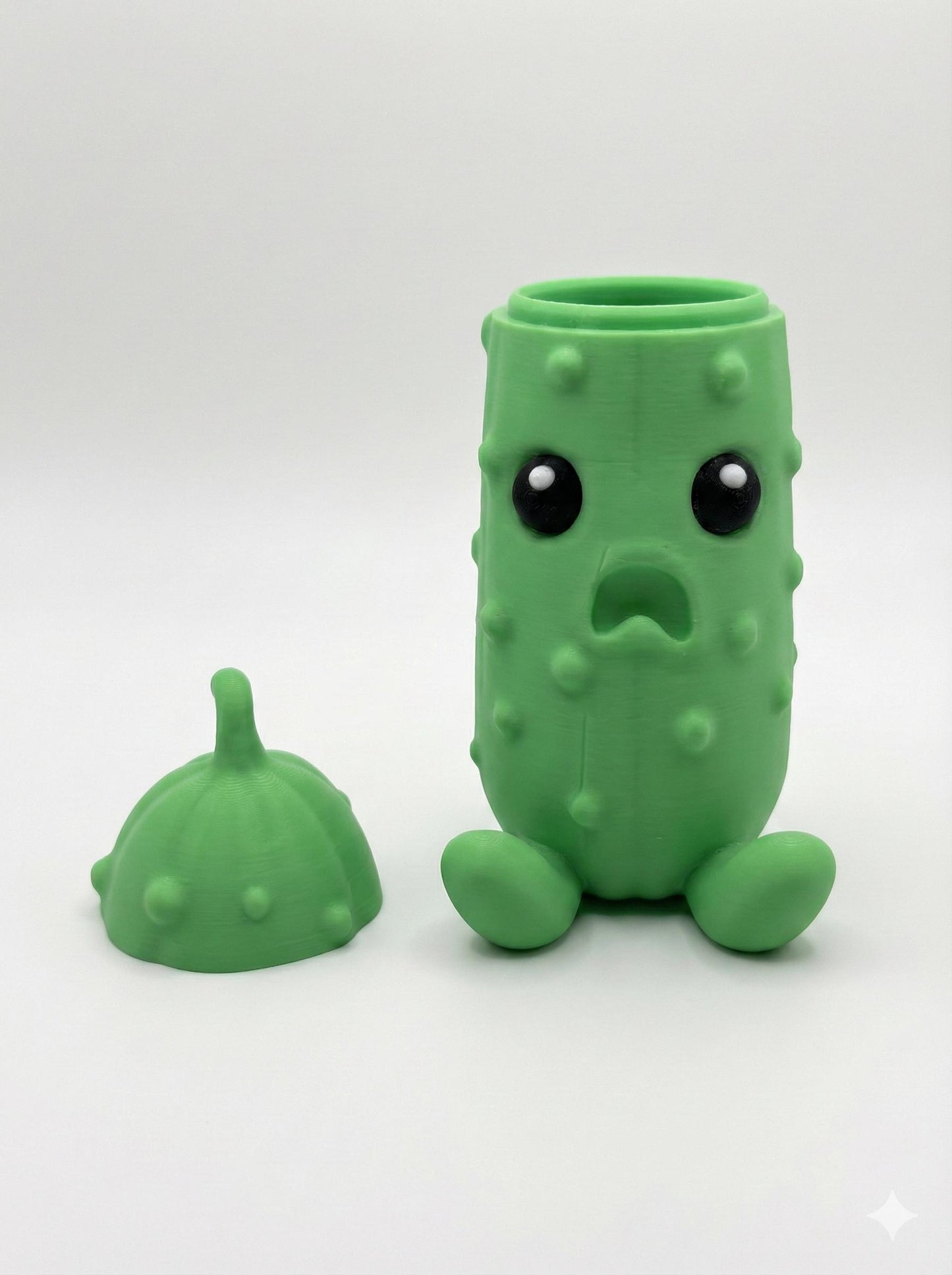 3D printed pickle statue displayed as quirky desk decor next to keyboard and office supplies
