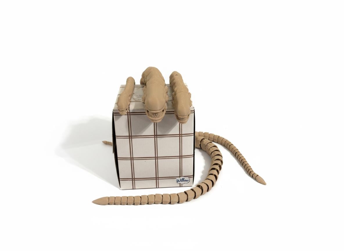 3D printed alien flexi toy wrapped around a human wrist and forearm
