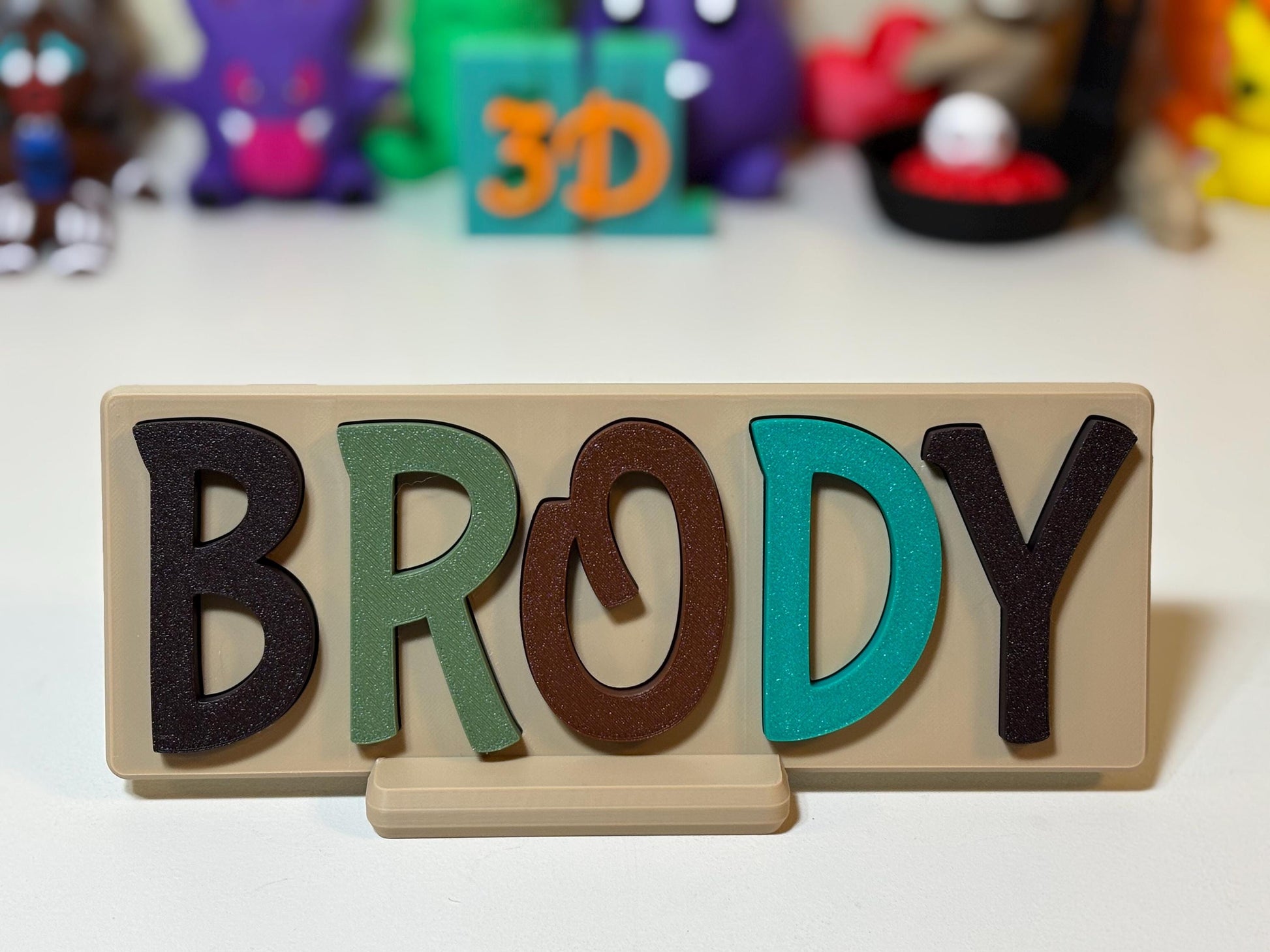 3D printed name puzzle in Tropical color theme displayed on nursery shelf