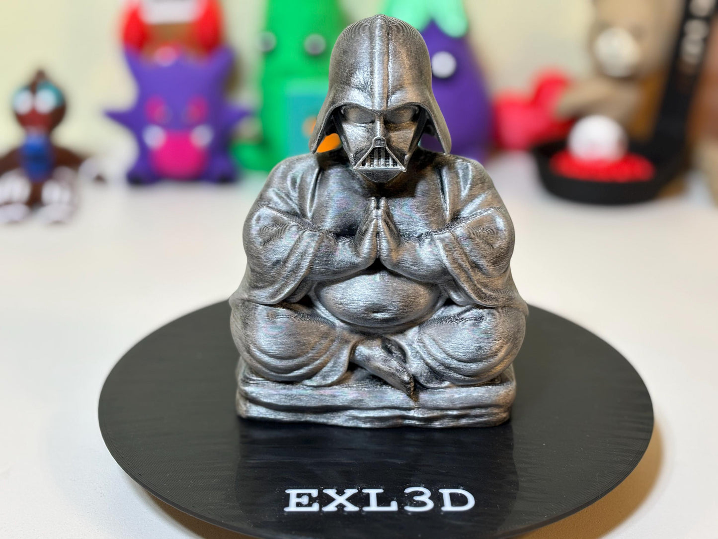 Top-down angle of 3D printed dark lord Buddha figurine showing head and shoulder detail