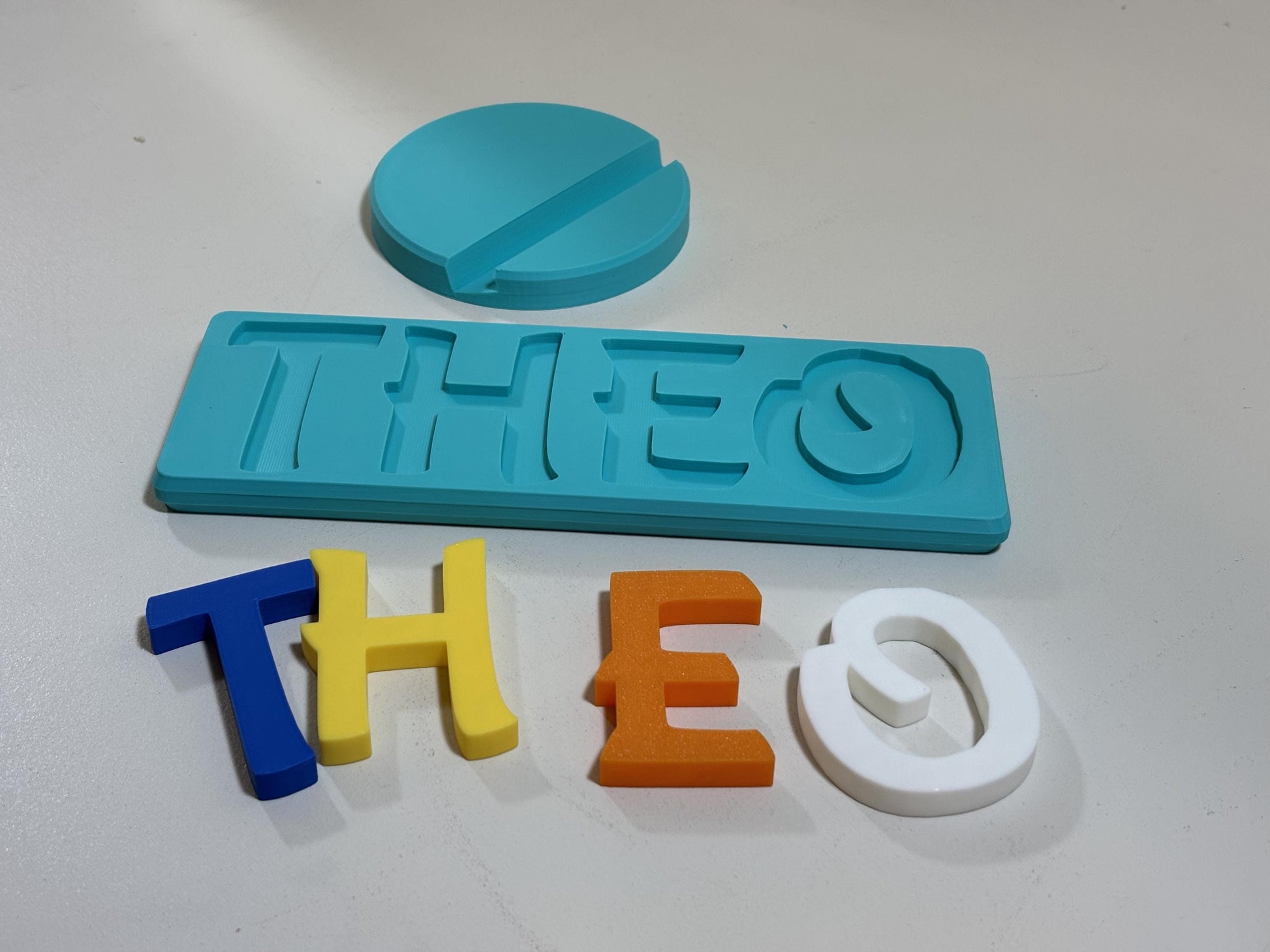 Personalized 3D printed name puzzle with colorful chunky letters on white background
