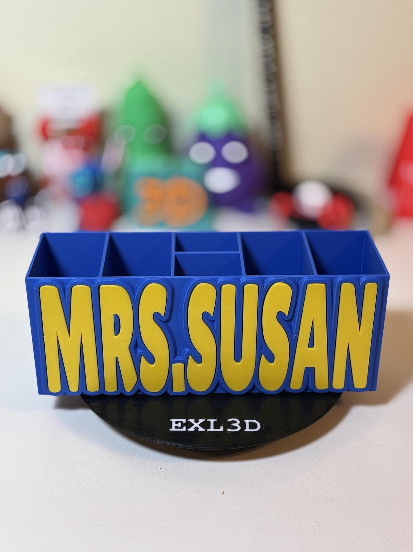 Custom 3D printed desk organizer with holographic shimmer nameplate on wood desk