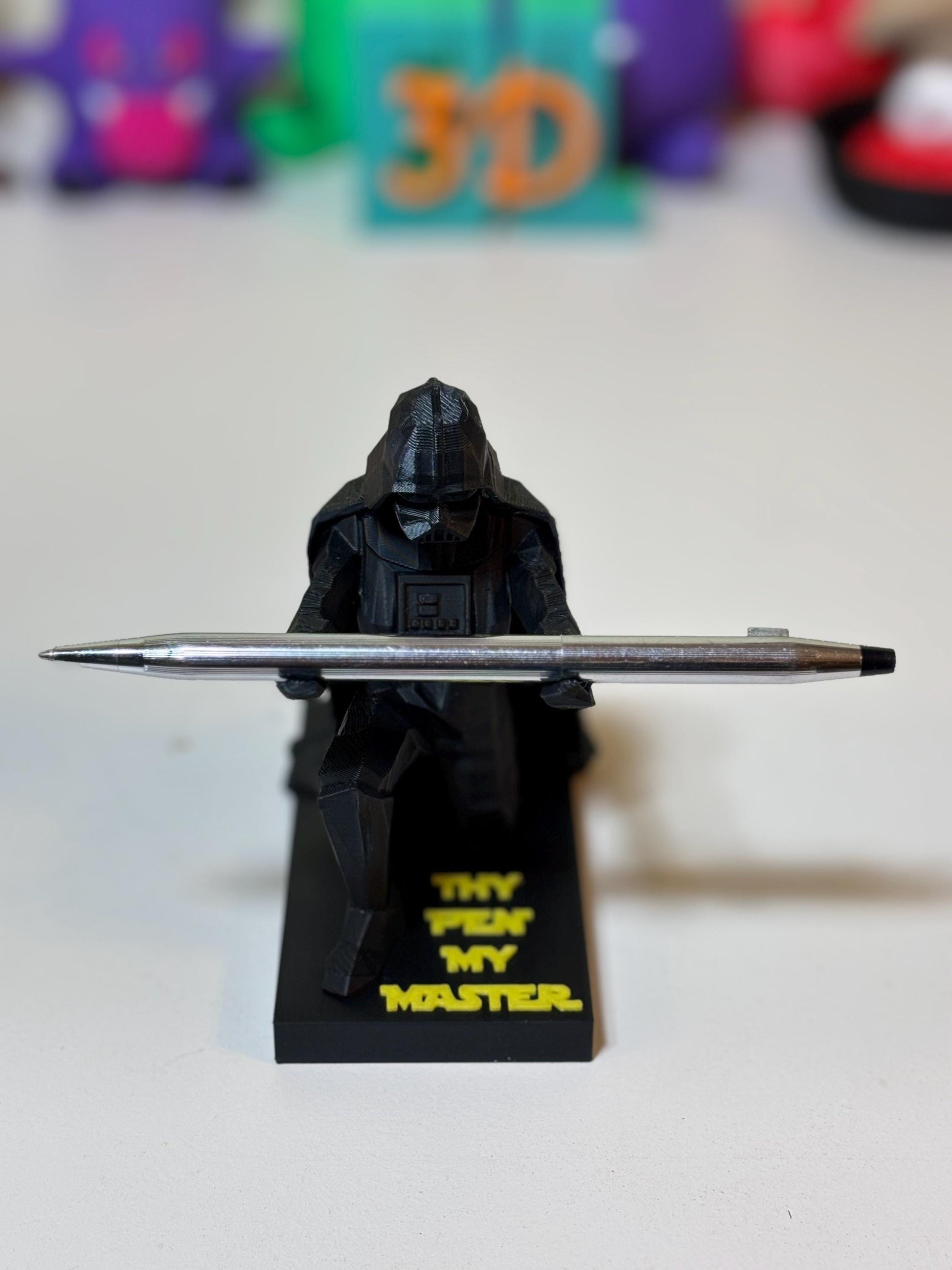 Low poly Vader ring holder with gold ring resting in hollow top opening