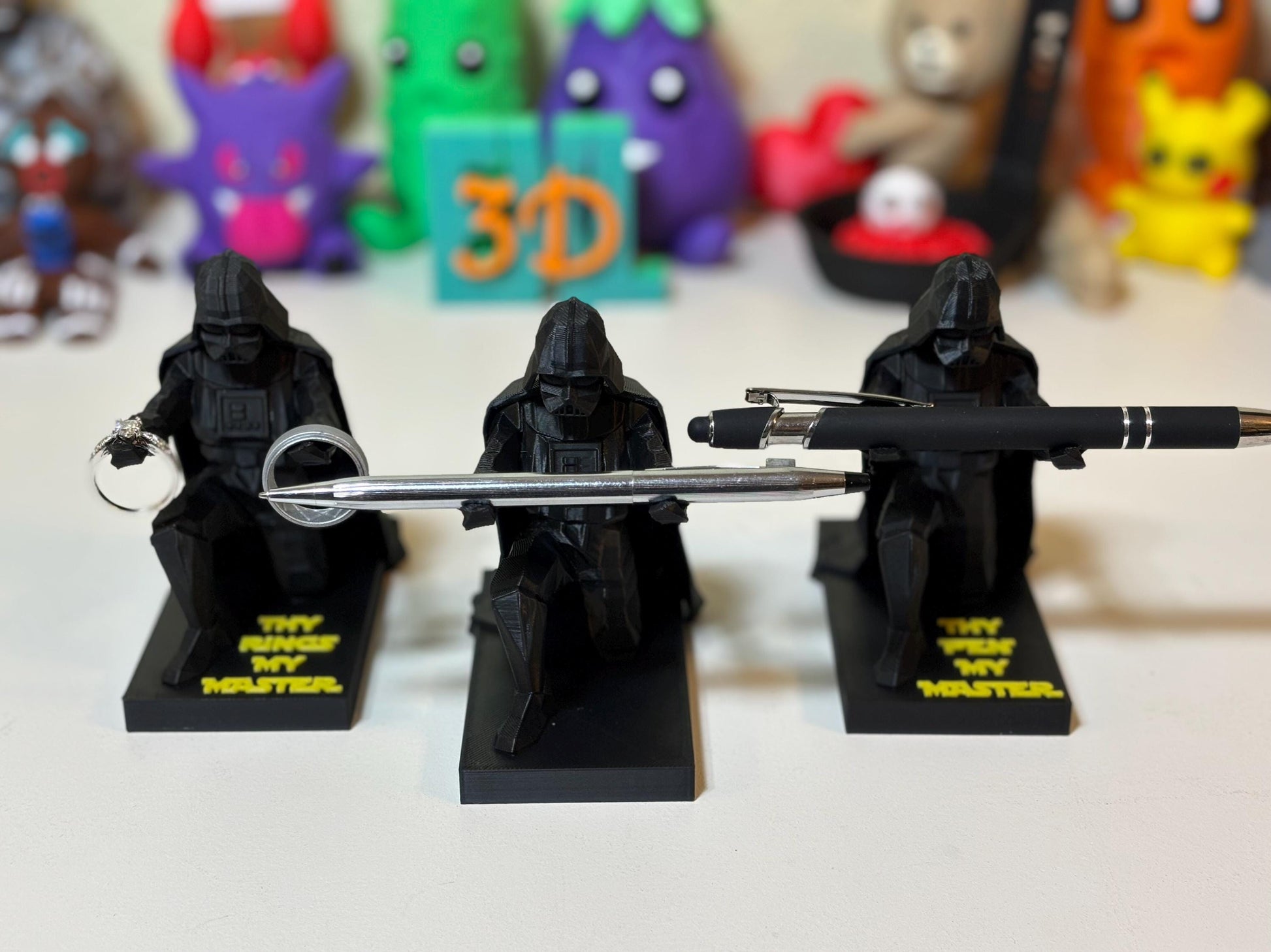 Low poly Darth Vader 3D printed pen holder in matte black on wooden desk