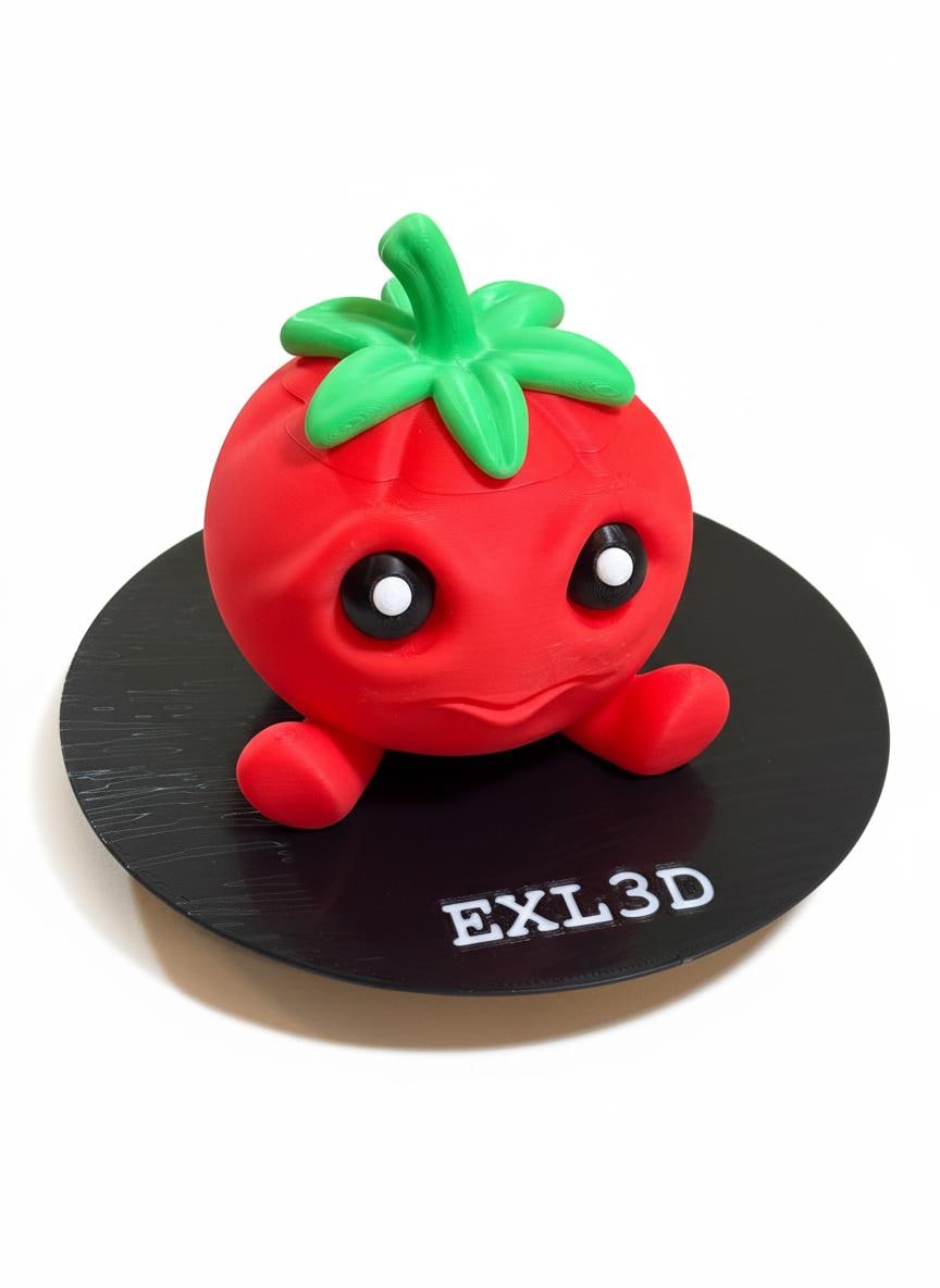 Red 3D printed tomato stash box with removable green stem lid on wooden desk