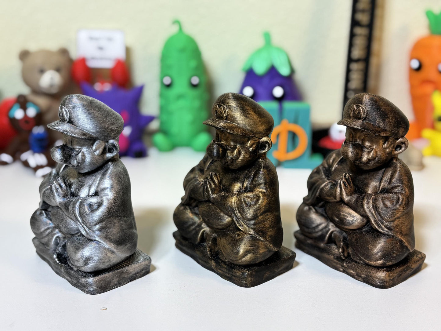 Front view of bronze finish zen plumber figurine matte black base