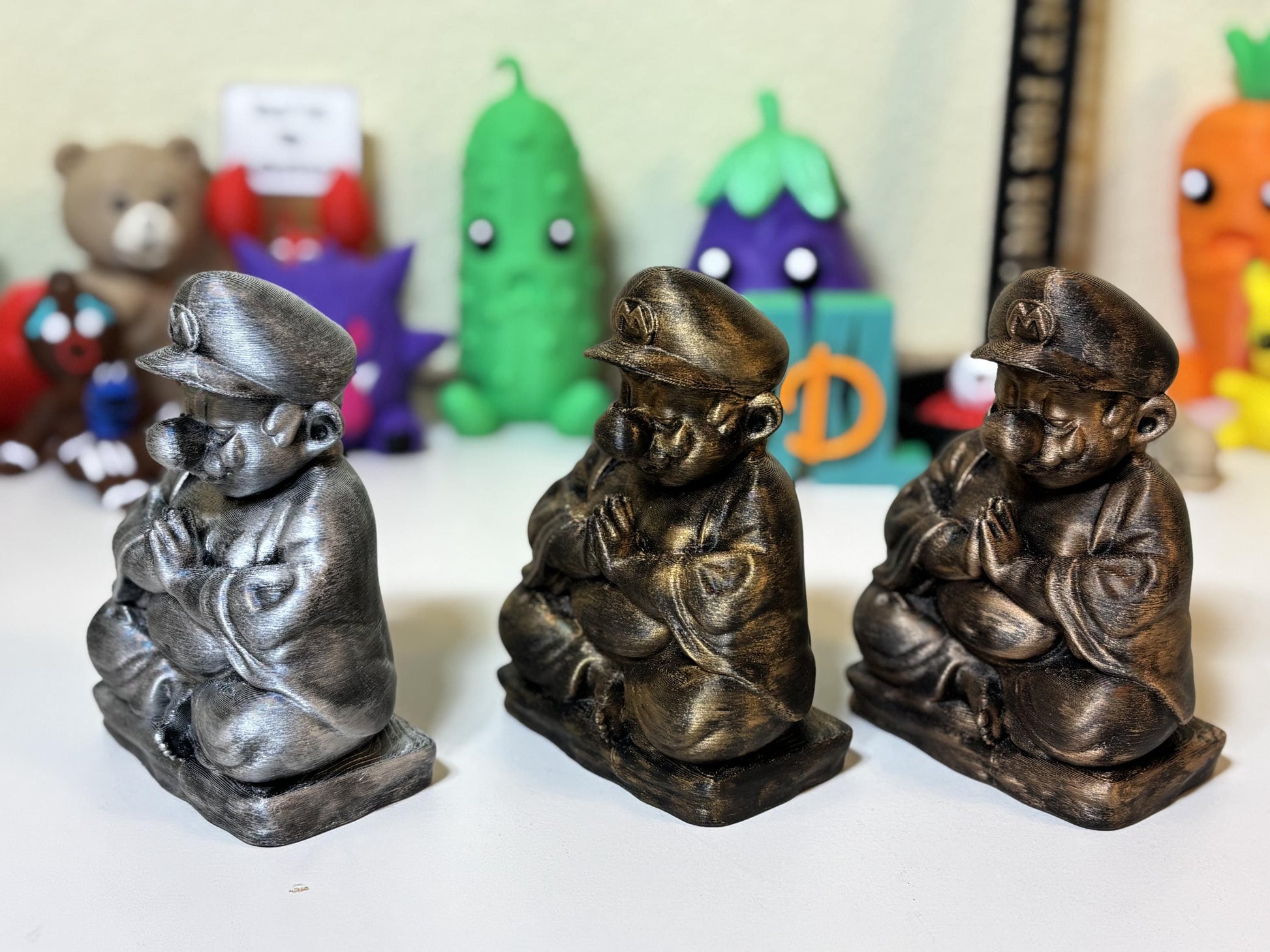 Front view of bronze finish zen plumber figurine matte black base