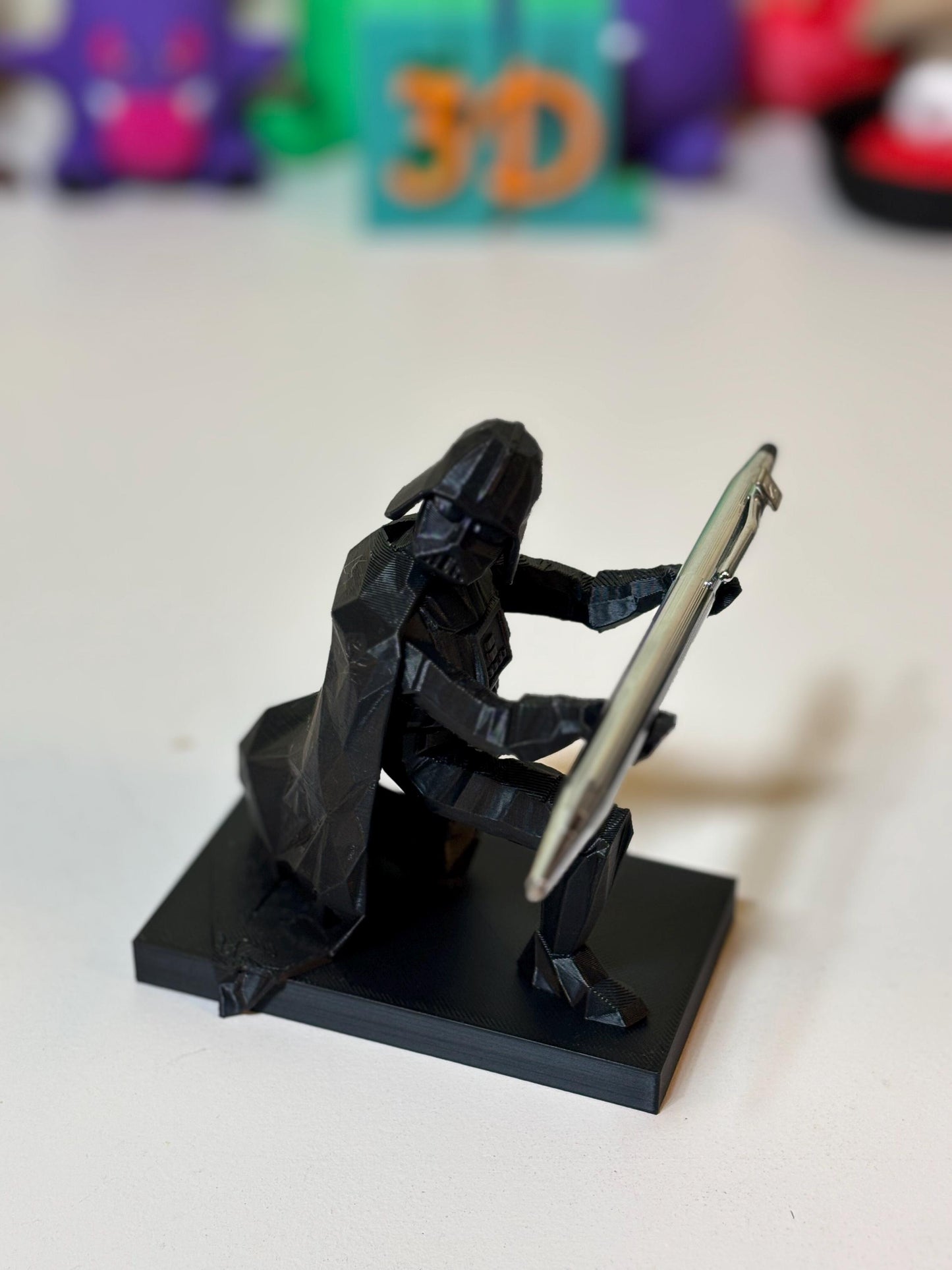 Low poly Vader pen holder holding ballpoint pen upright on office desk