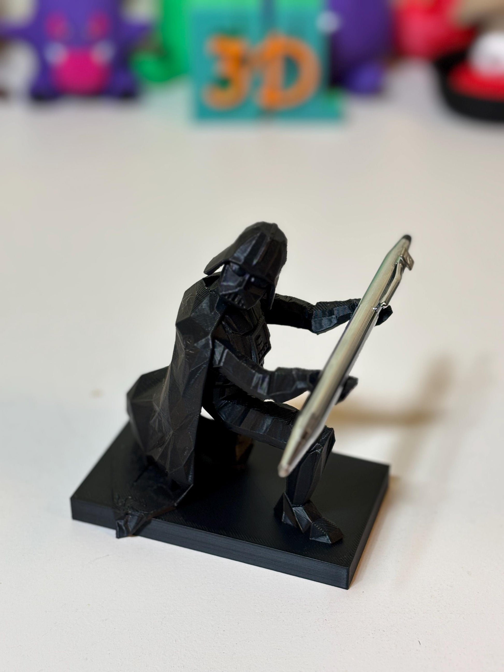 Low poly Vader pen holder holding ballpoint pen upright on office desk