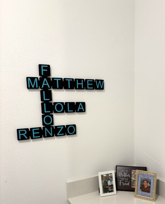 Custom 3D printed white letter wall tiles spelling family name on modern wall