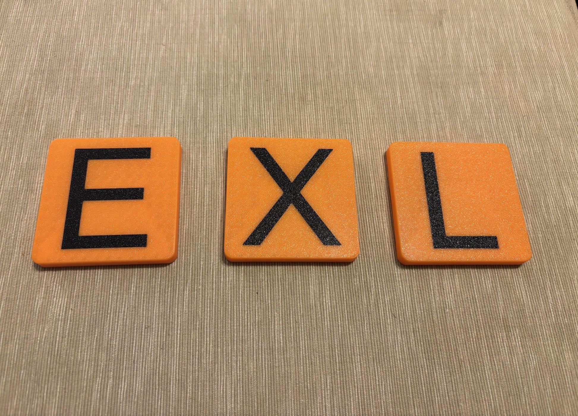 Mix and match color 3D printed letter tiles mounted neatly in living room