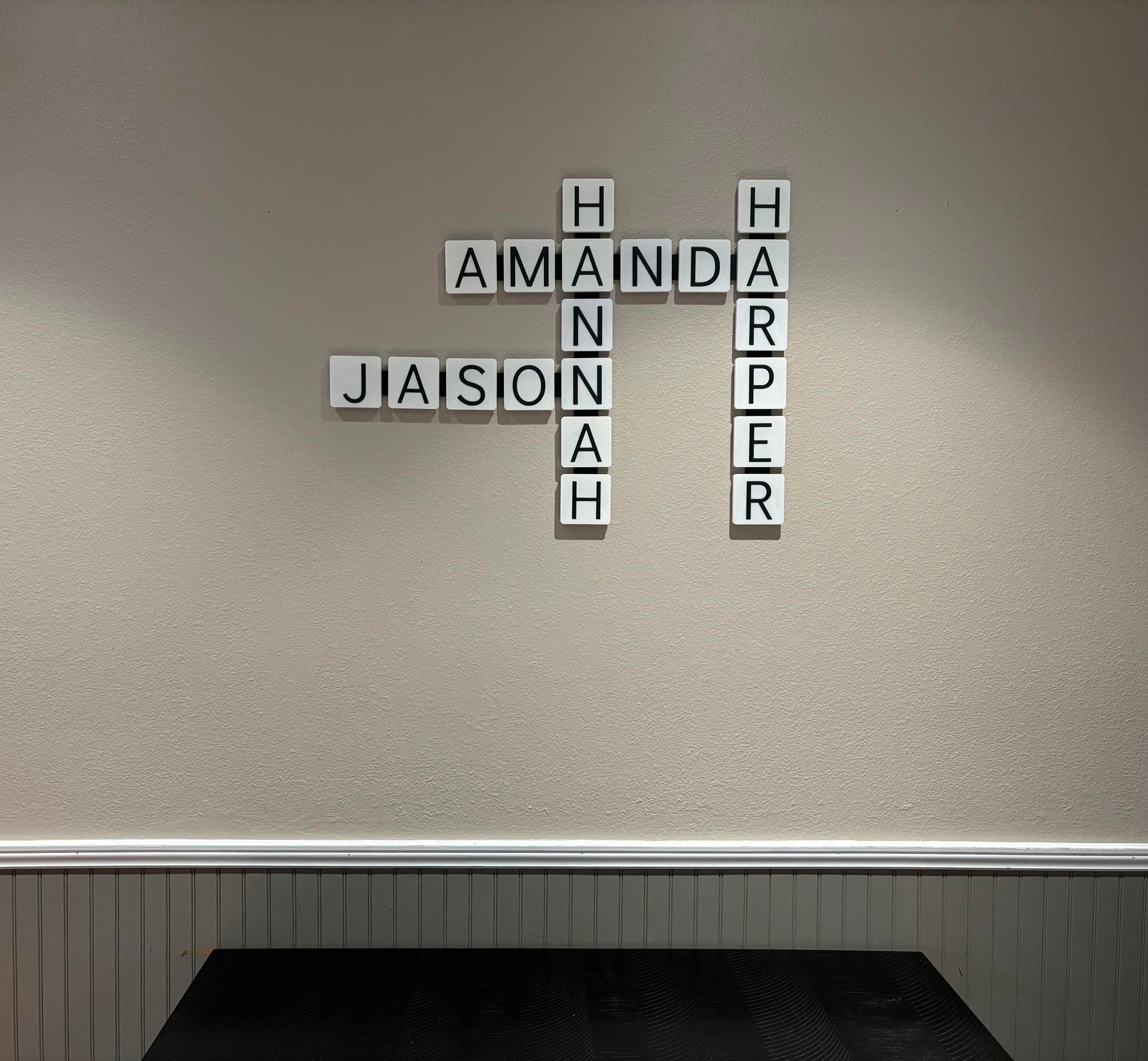 Bold orange 3D printed wall tiles arranged as personalized word display