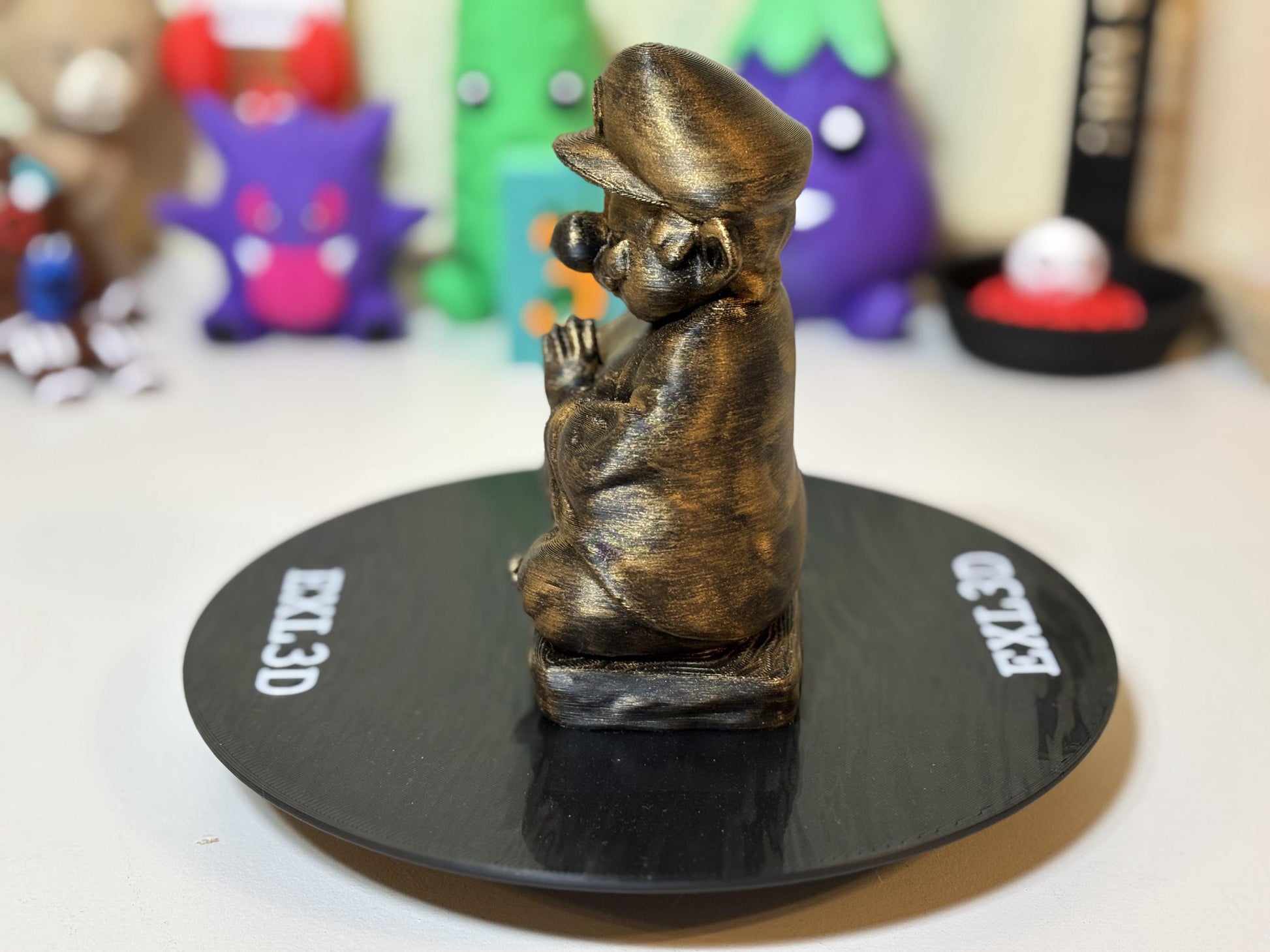 3D printed gamer desk decor statue among cacti and monitor