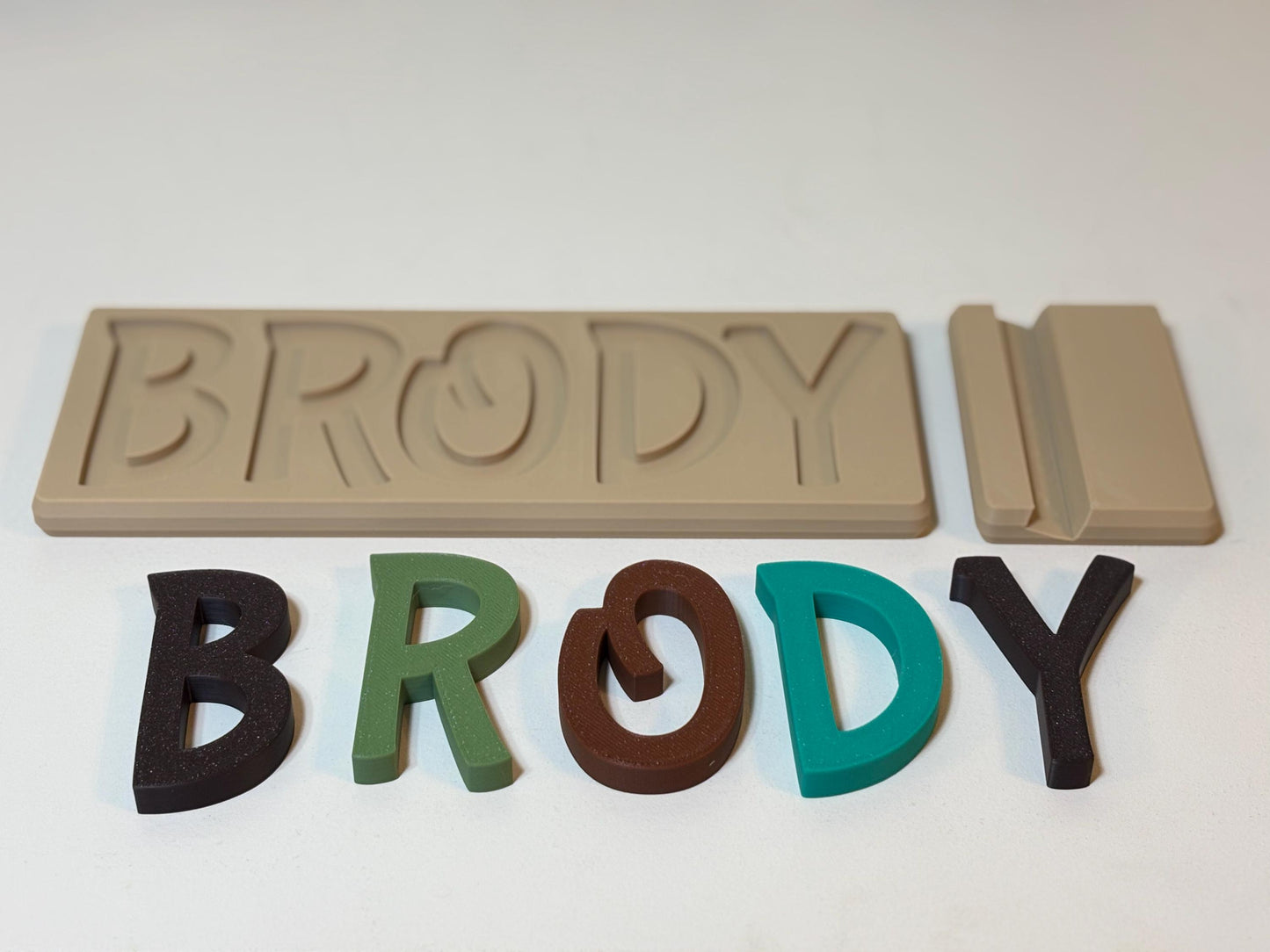 3D printed name puzzle in Primary colors styled in modern toddler bedroom setting