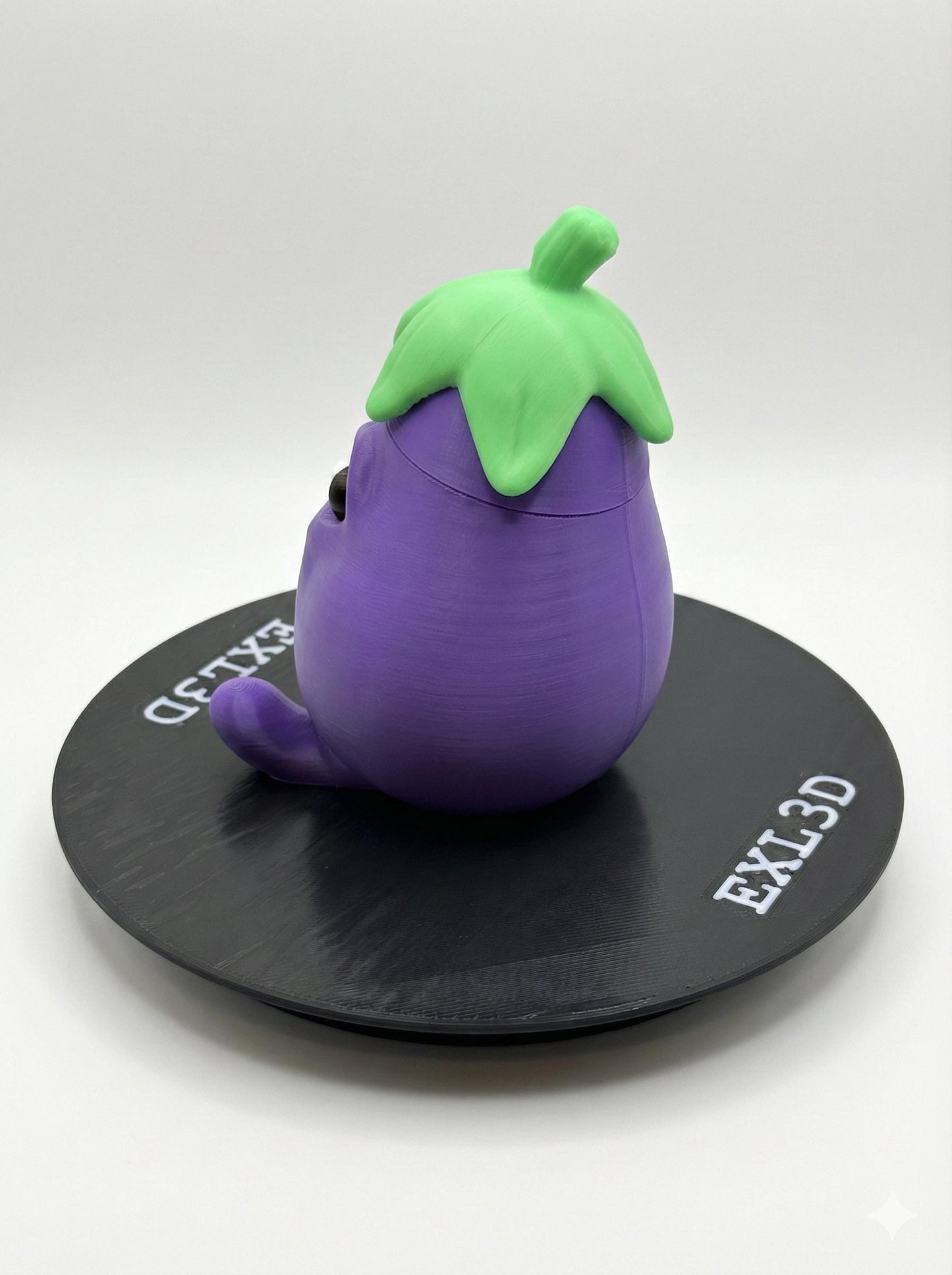 3D printed kawaii eggplant statue side angle showing stable base and vibrant purple PLA finish