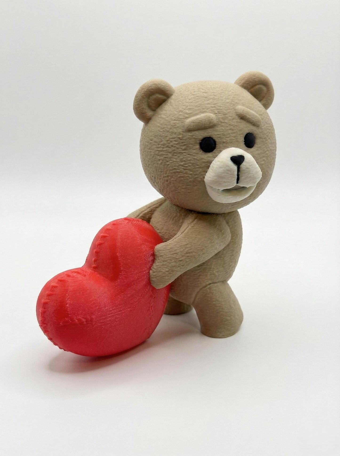 Close-up of 3D printed bear statue on gaming desk showing matte PLA detail