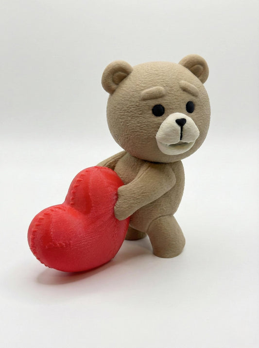 Close-up of 3D printed bear statue on gaming desk showing matte PLA detail