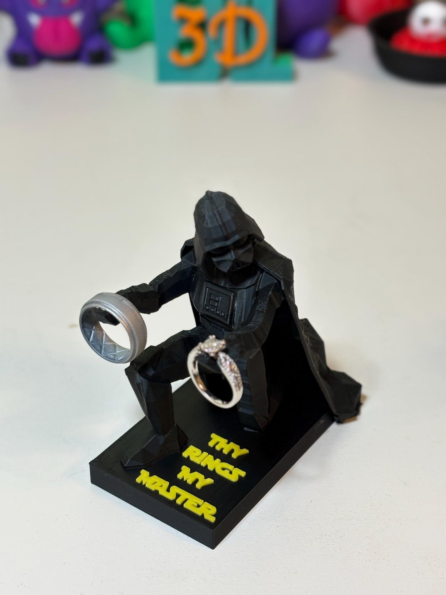 3D printed Vader figure on nightstand next to lamp as bedside ring holder