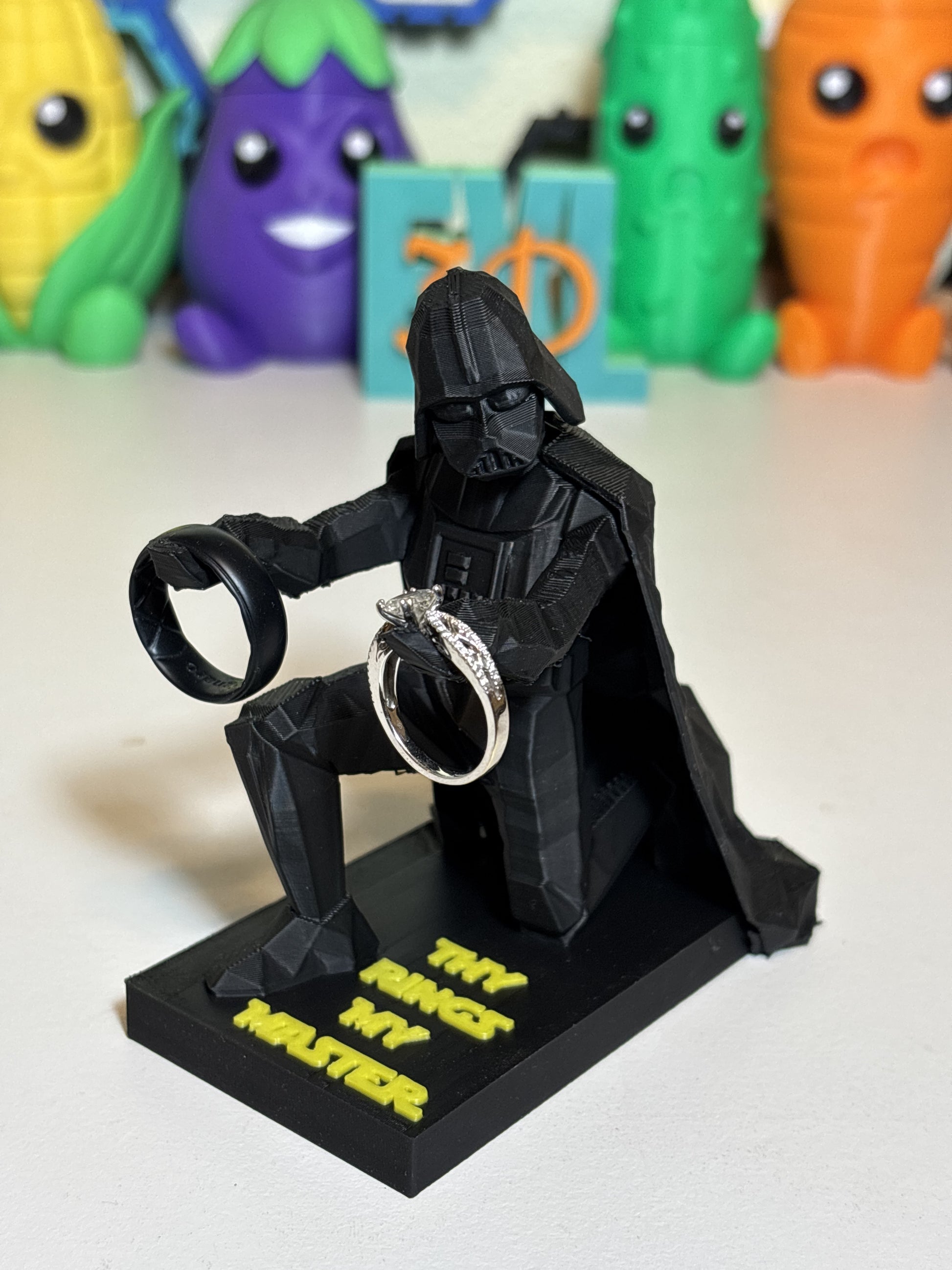Overhead shot of low poly Vader hollow top cradle holding ring and pen together