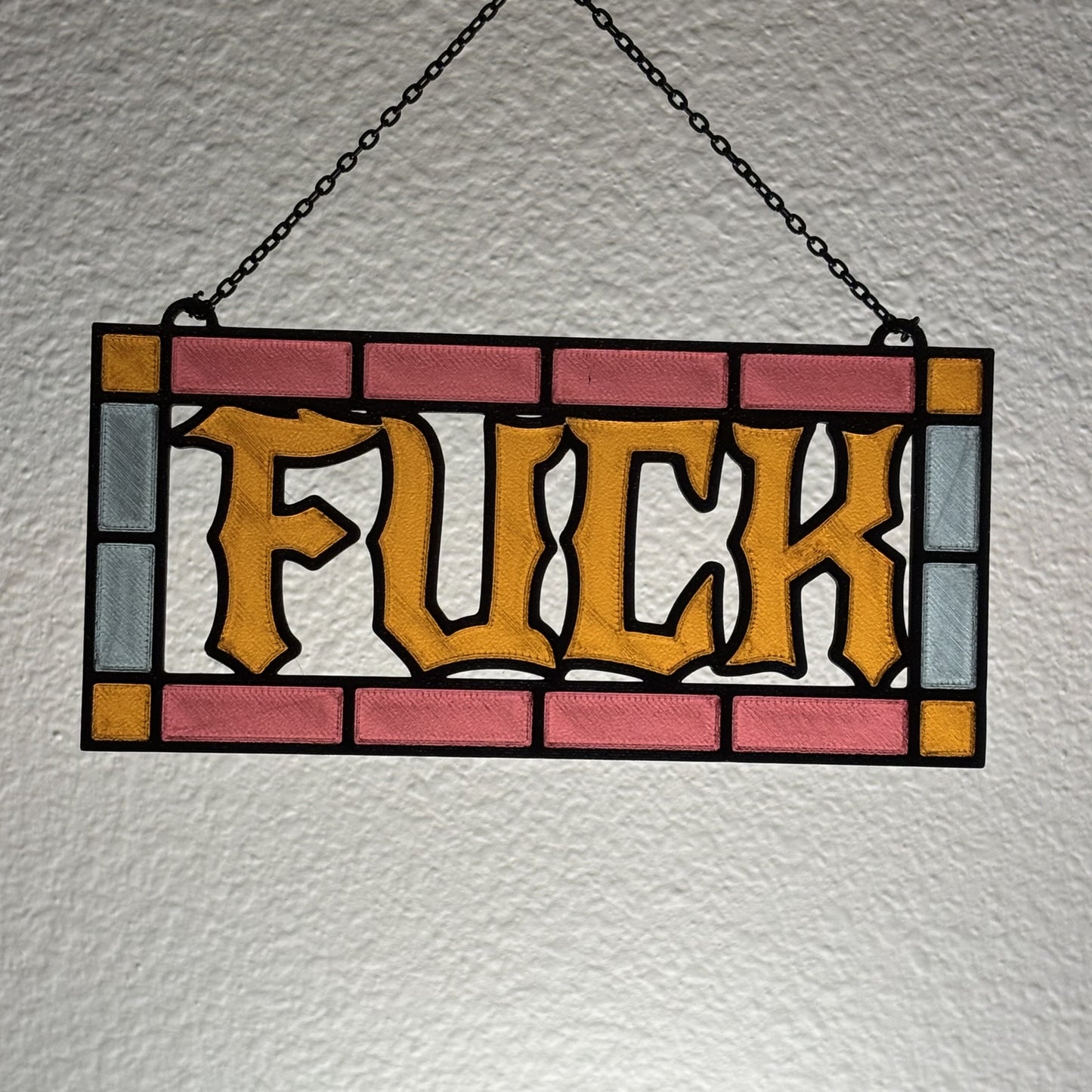 Studio shot of 3D printed suncatcher showing stained glass inspired line work