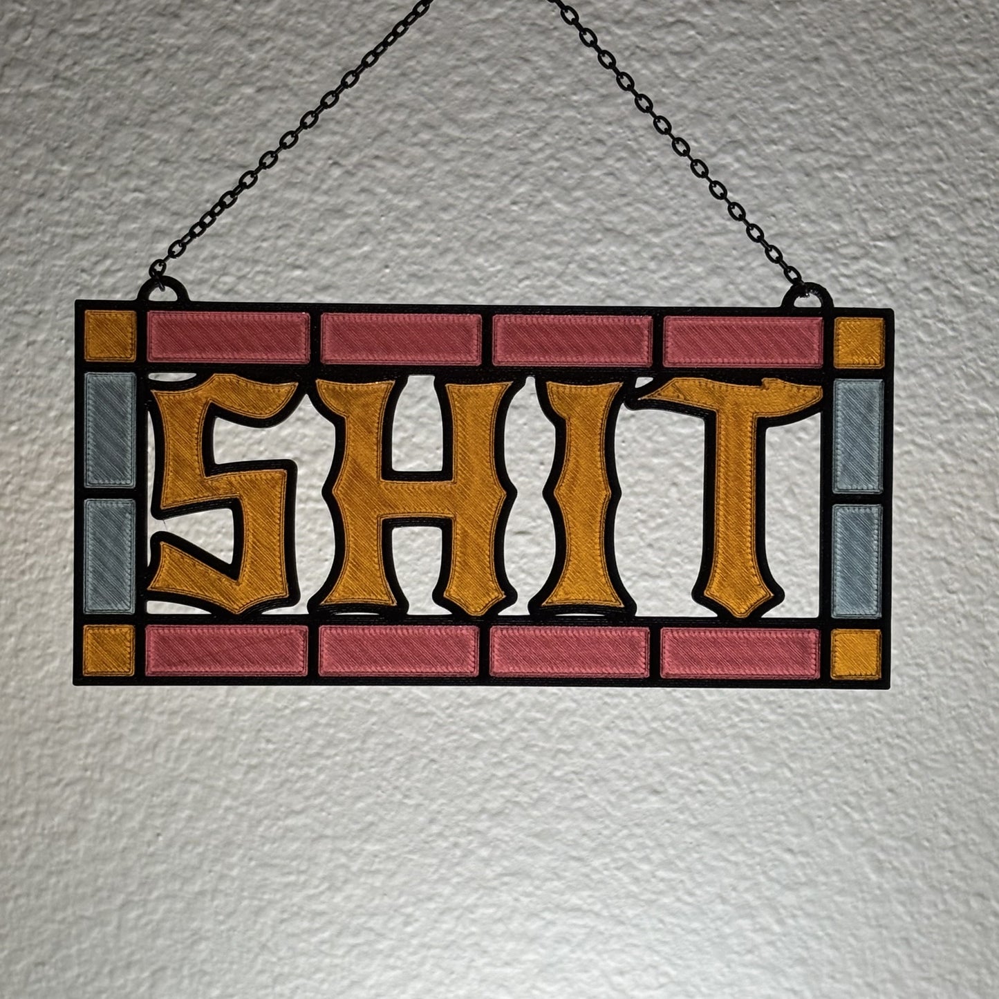 Blue and purple multicolor suncatcher hanging in cozy apartment window setting