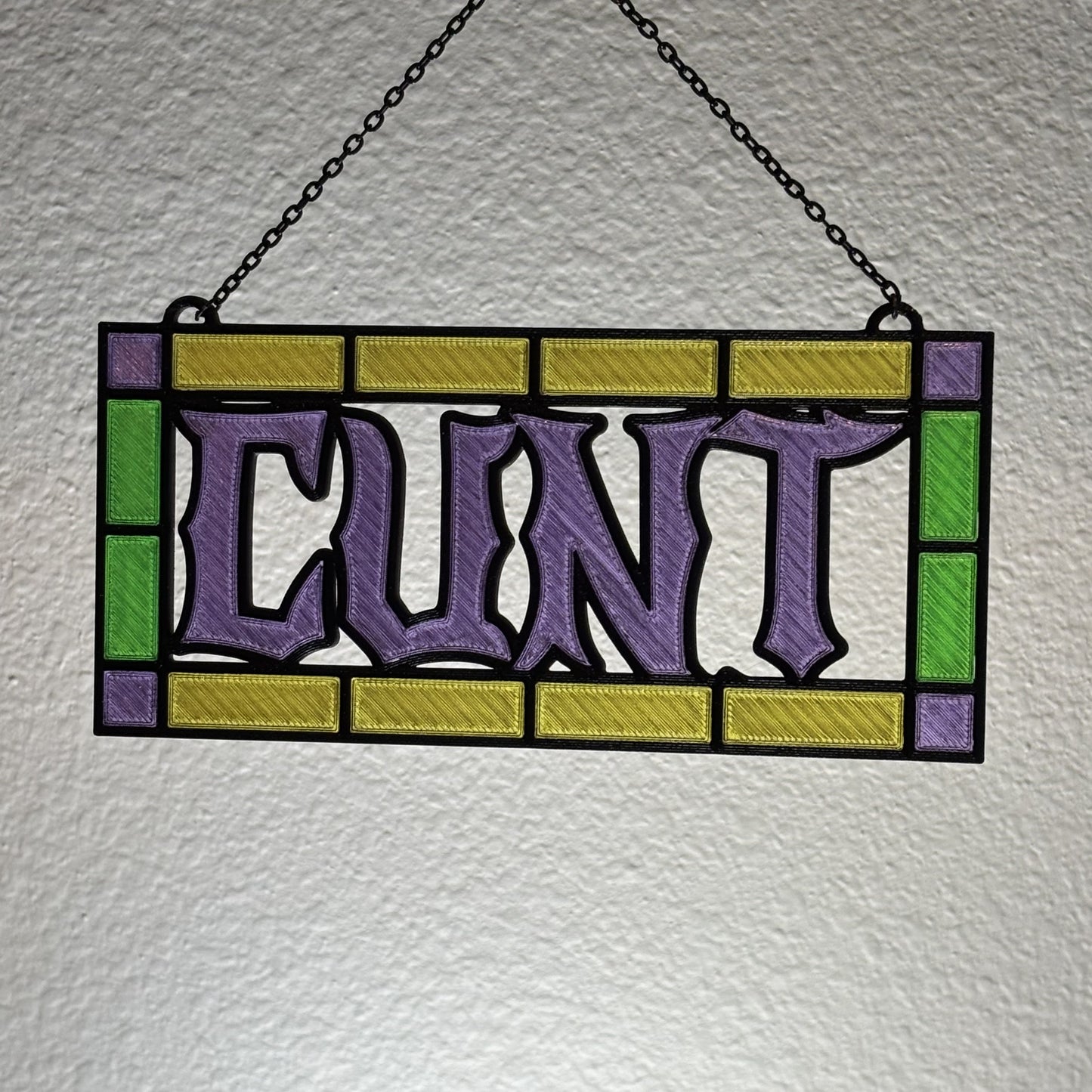 Green colorway spicy suncatcher with stained glass hue effect in sunlight