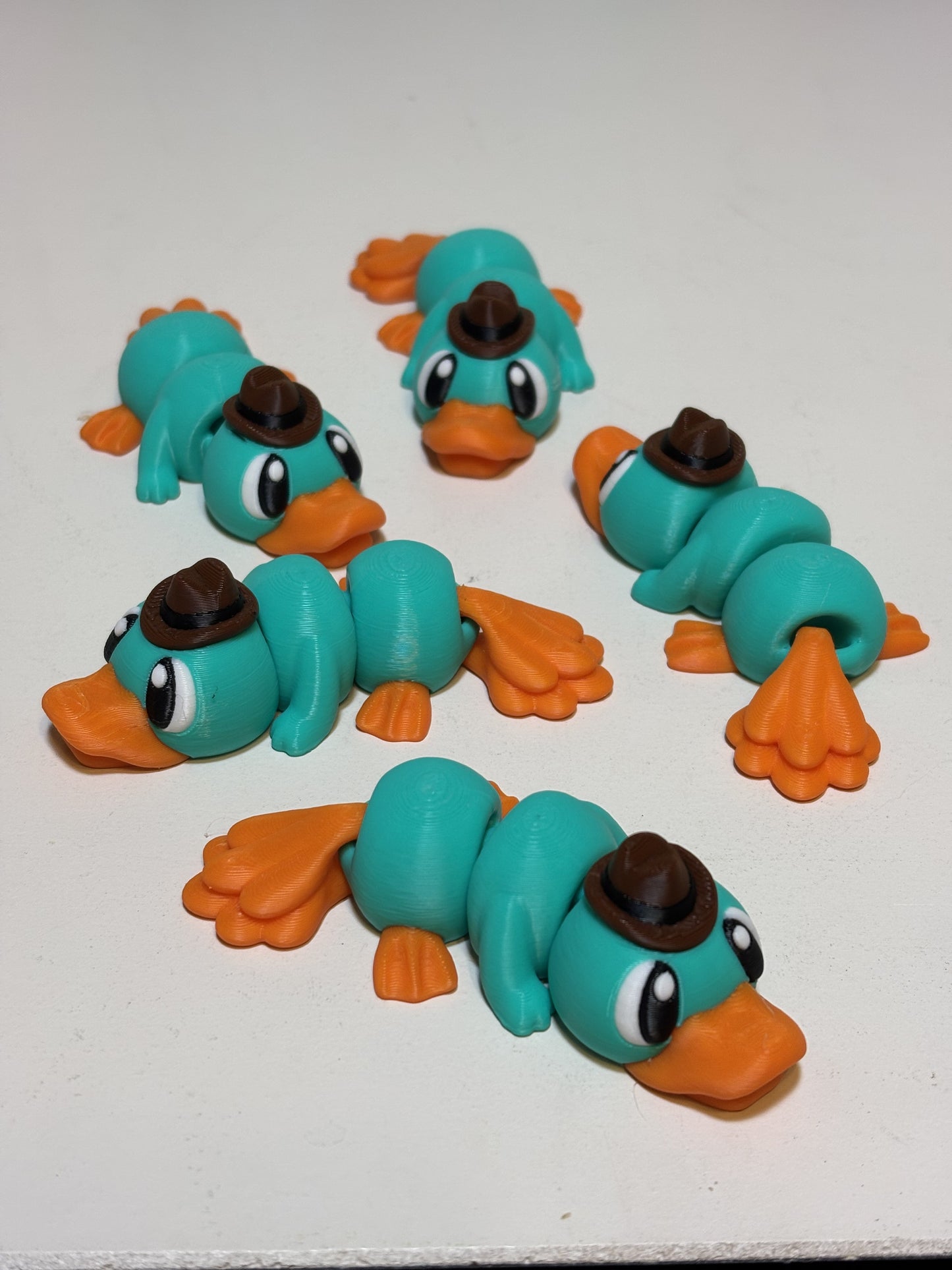 Overhead flat lay of articulated 3D printed sea creature and dragon figures