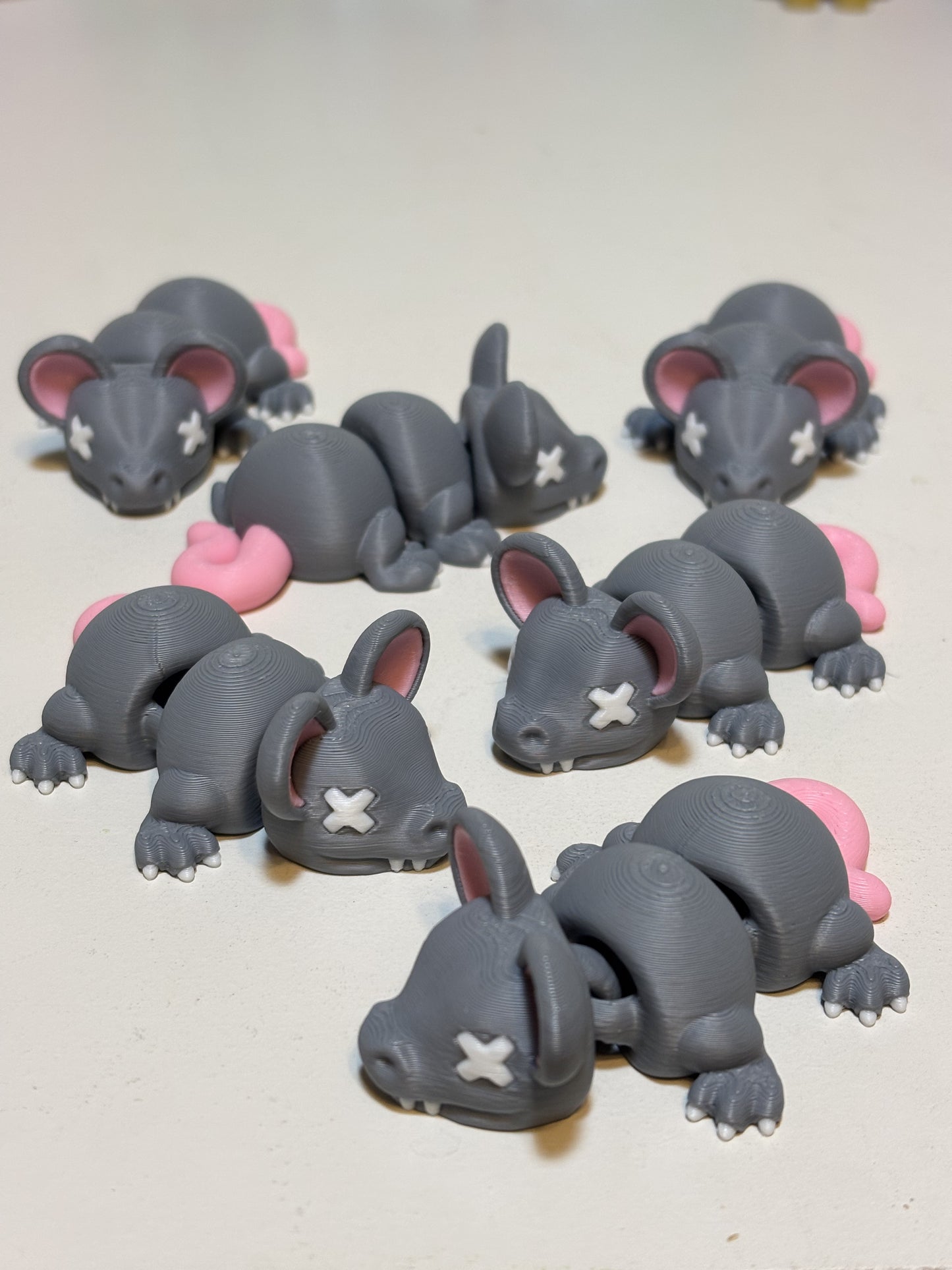 3D printed flexi animal figures next to ruler showing three to six inch scale