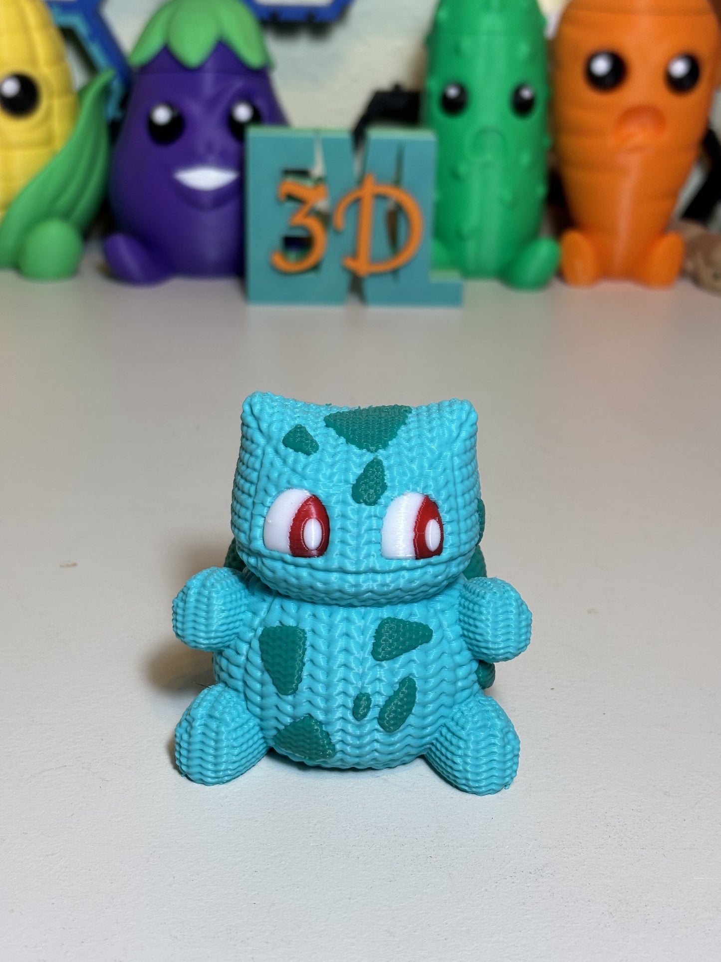 3D printed Bulbasaur sculpture gift displayed on shelf with plant decor