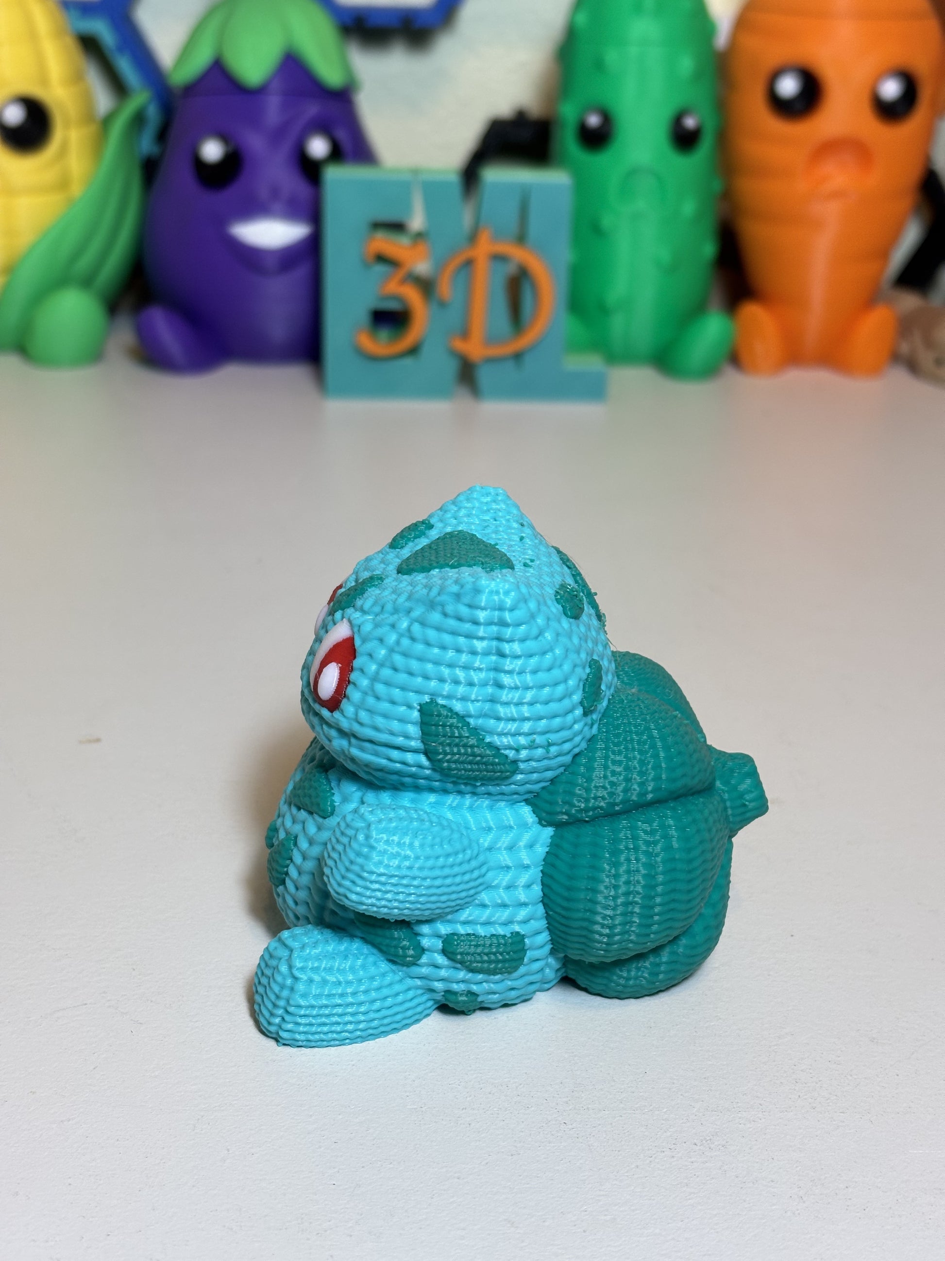 Side angle view of faux knit Bulbasaur 3D printed statue showing detail
