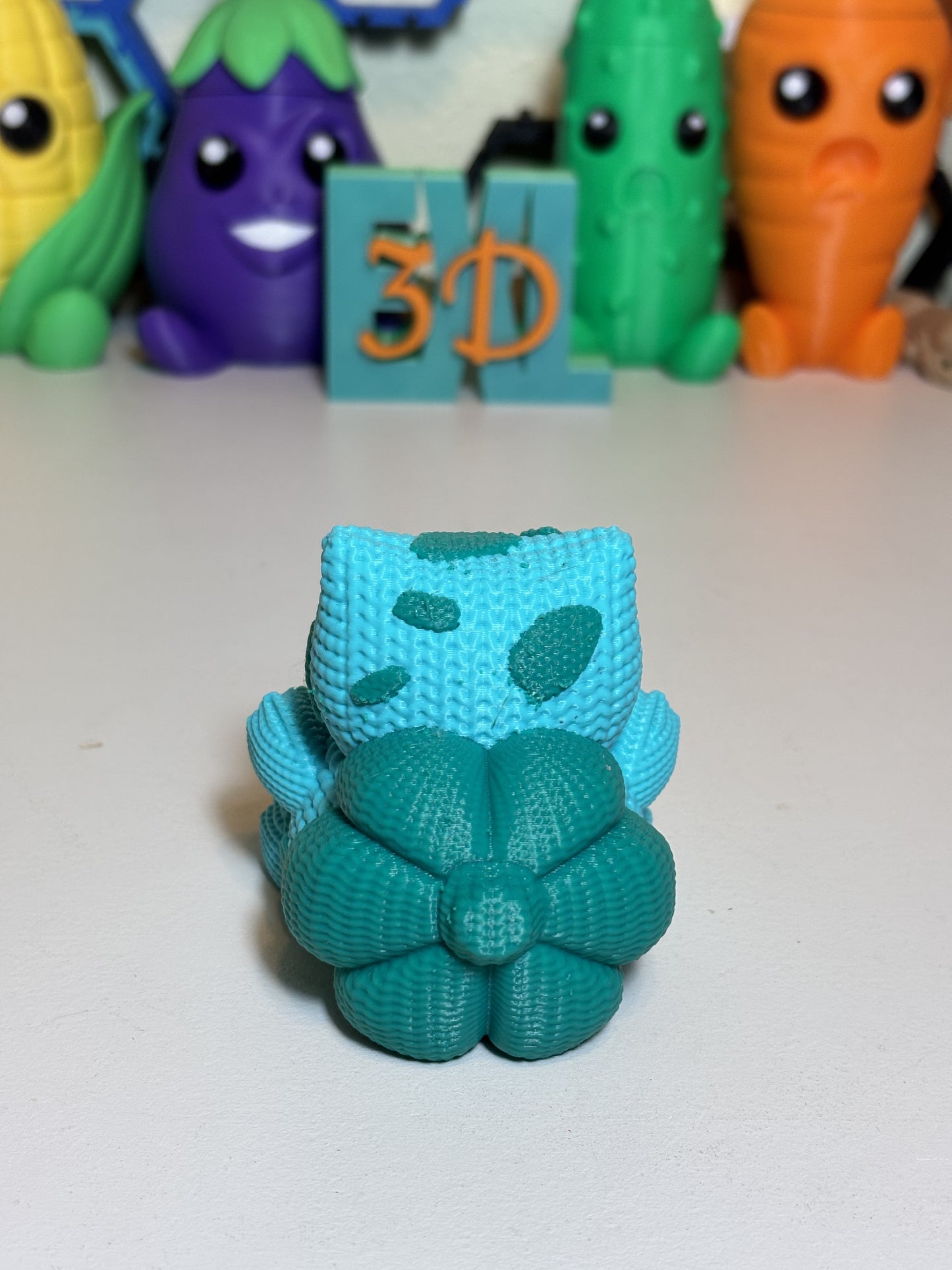 Faux knit Bulbasaur figurine 3D printed collectible against neutral background