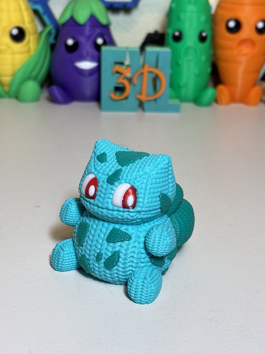 Faux knit Bulbasaur 3D printed decorative statue on wooden desk surface