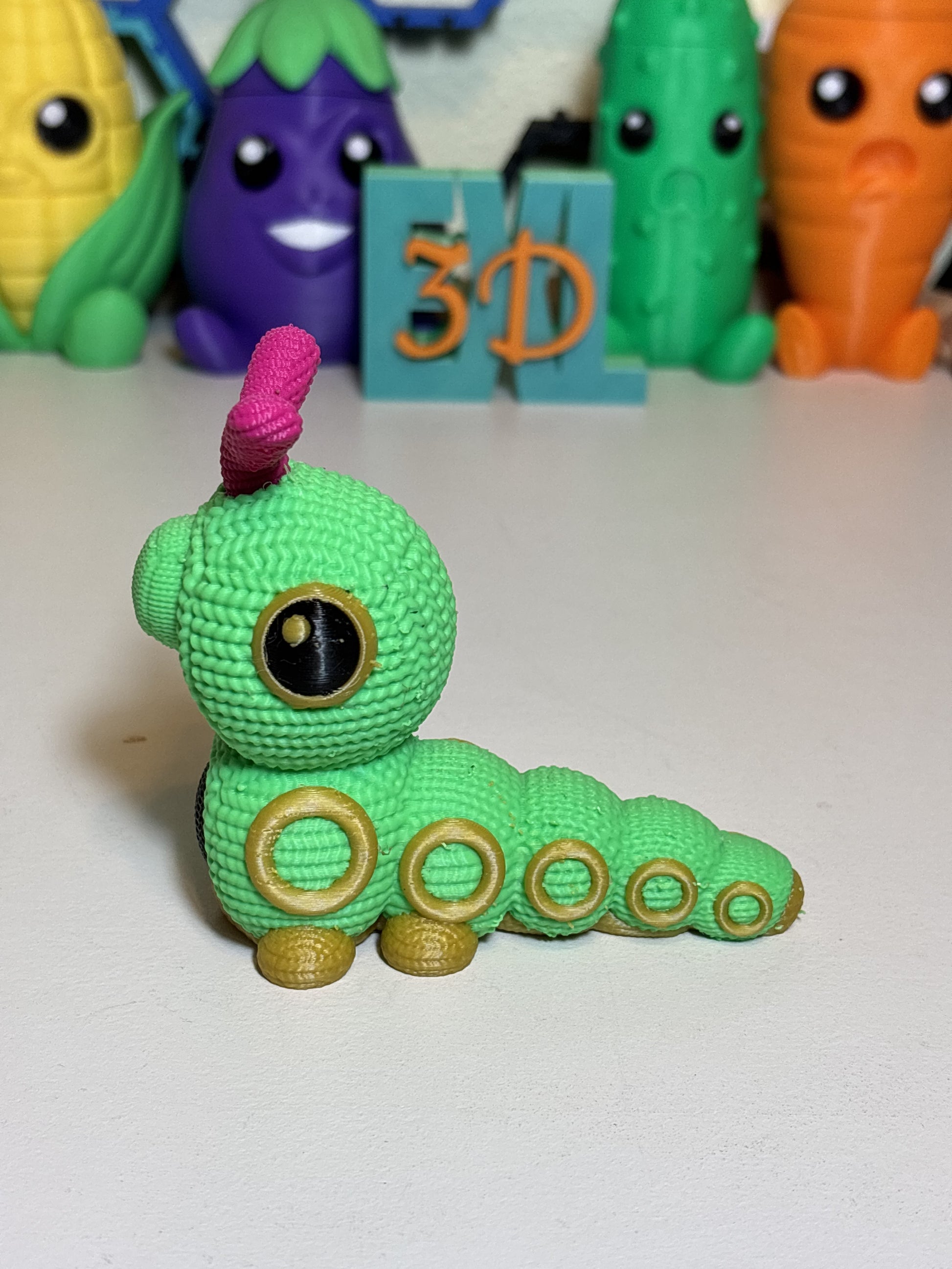 3D printed Caterpie decorative sculpture shown from front angle on shelf