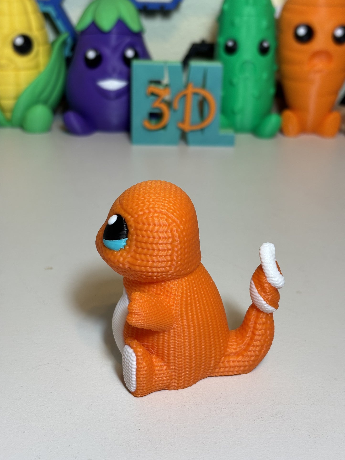 3D printed Charmander sculpture side angle showing flame tail detail