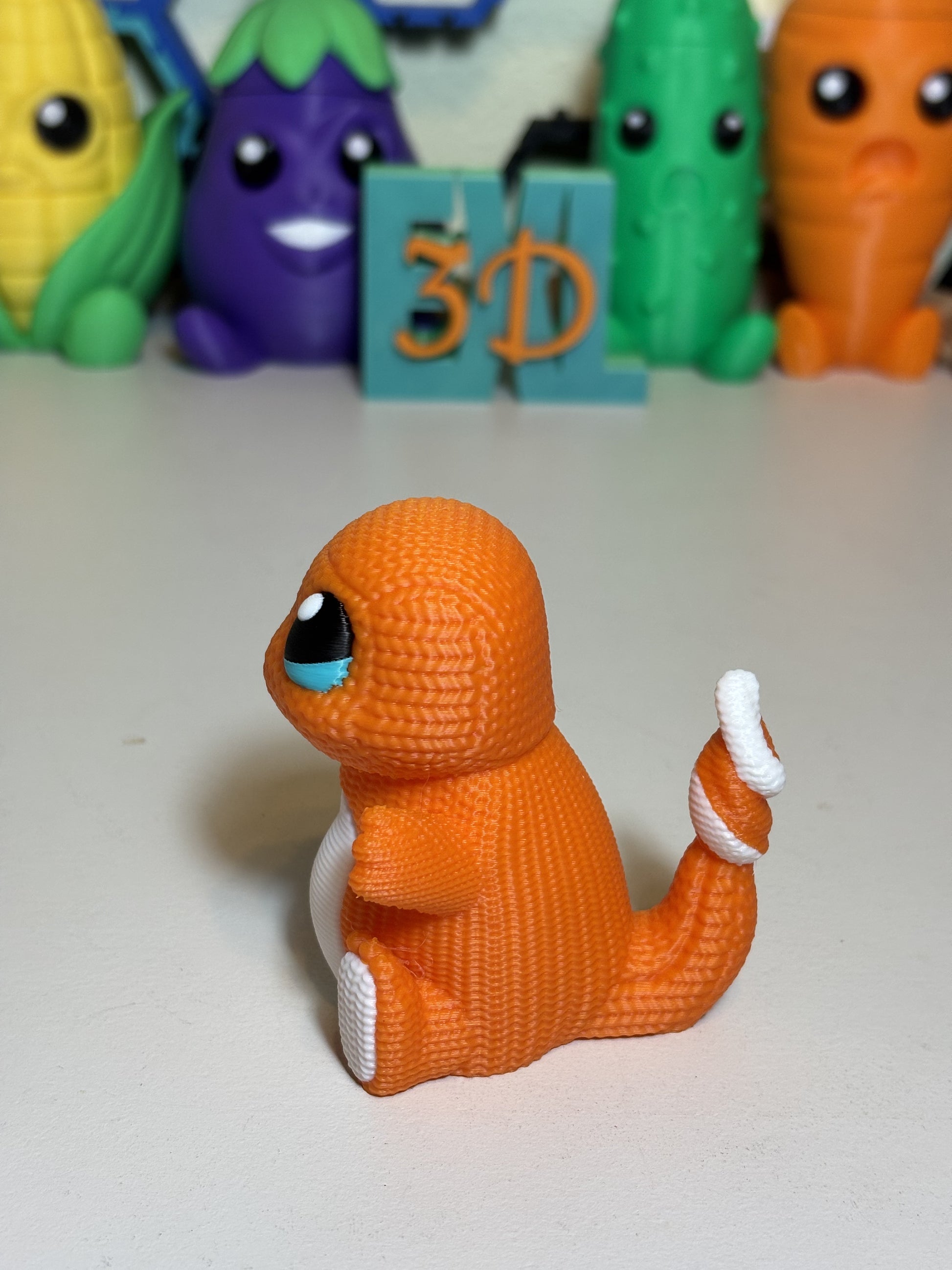 3D printed Charmander sculpture side angle showing flame tail detail