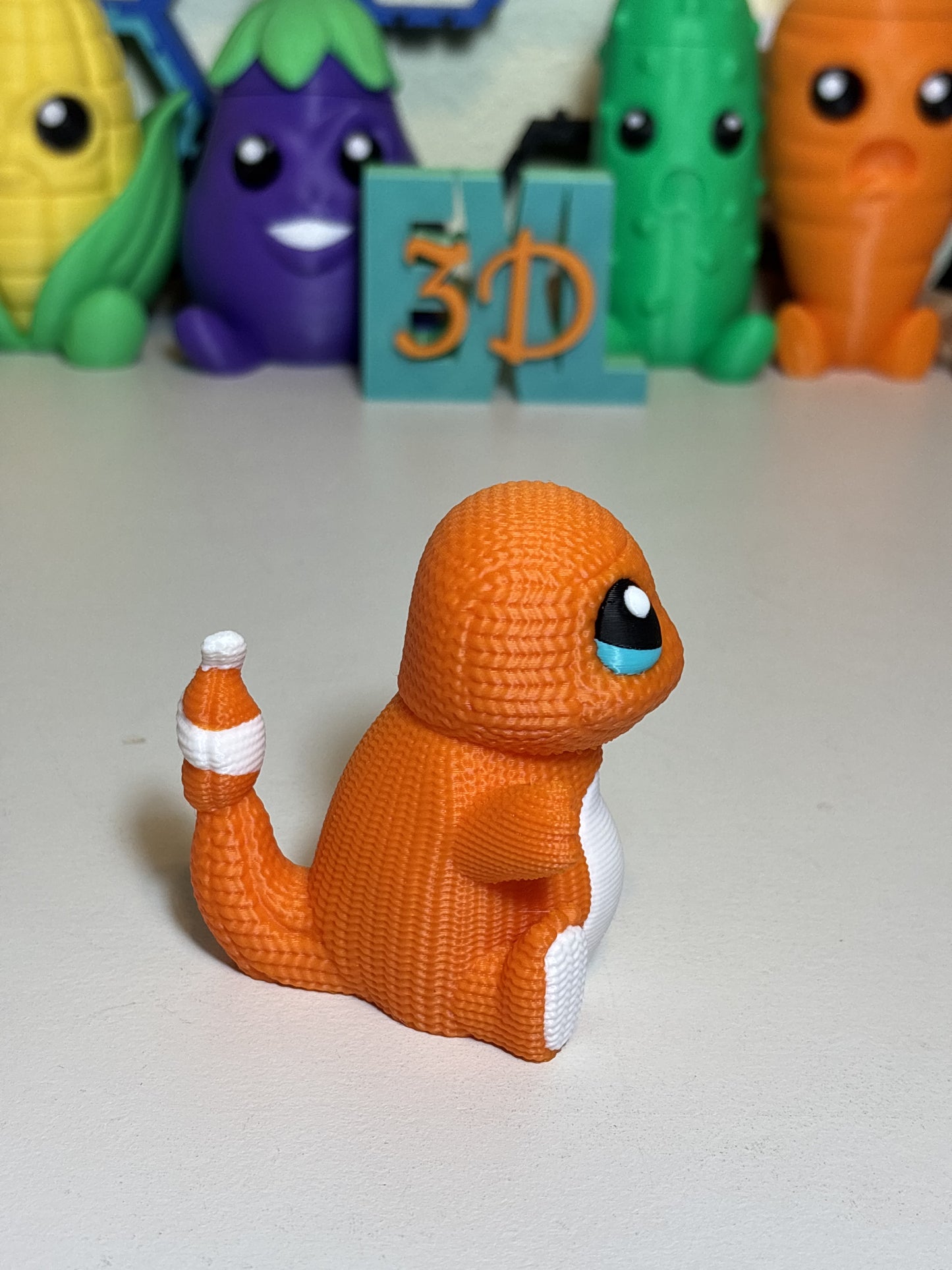 Top-down view of 3D printed Charmander statue showing knit texture pattern