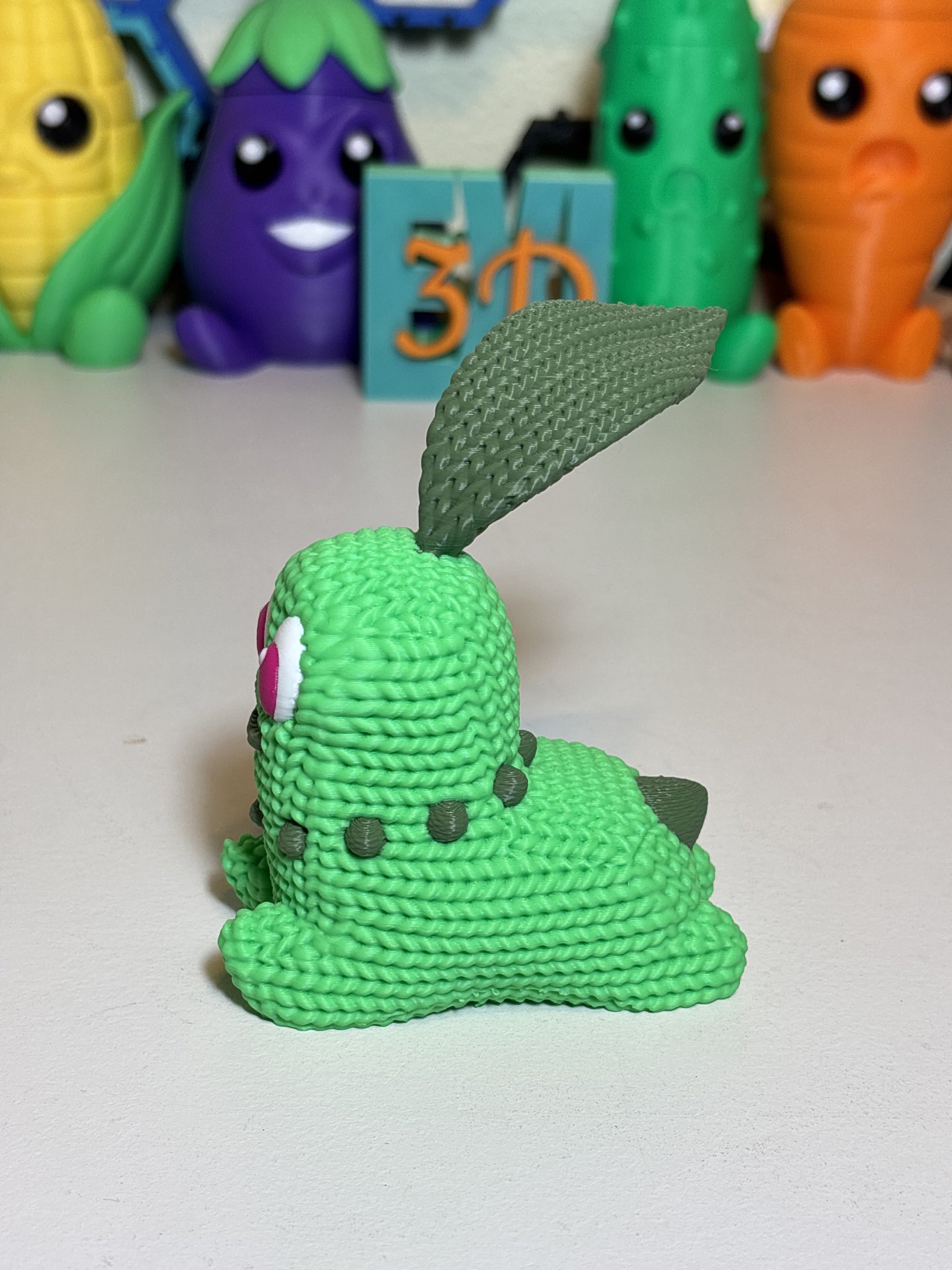 3D printed Chikorita figurine styled on wooden desk as decor