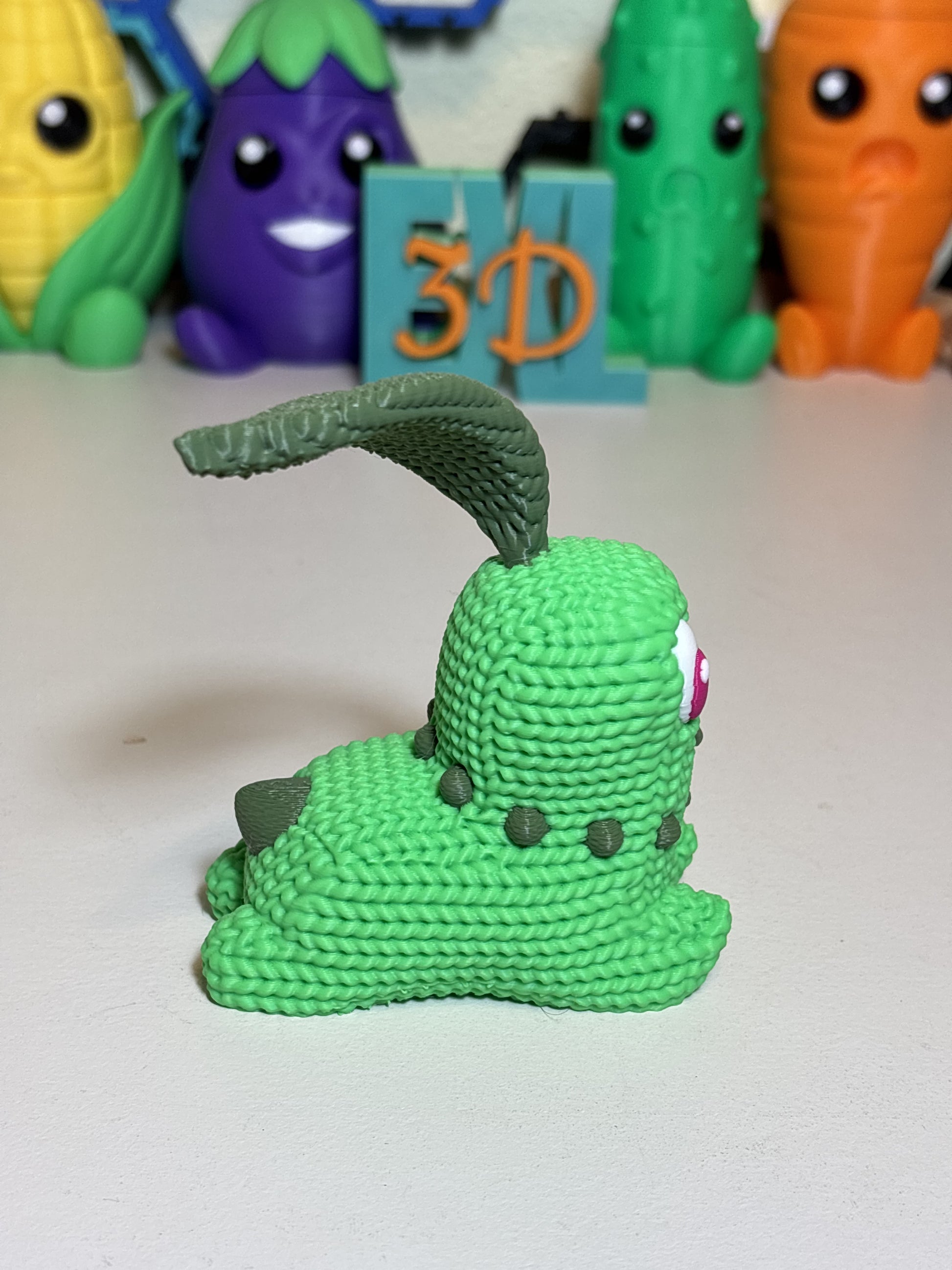 3D printed Chikorita gift figure next to everyday objects for scale