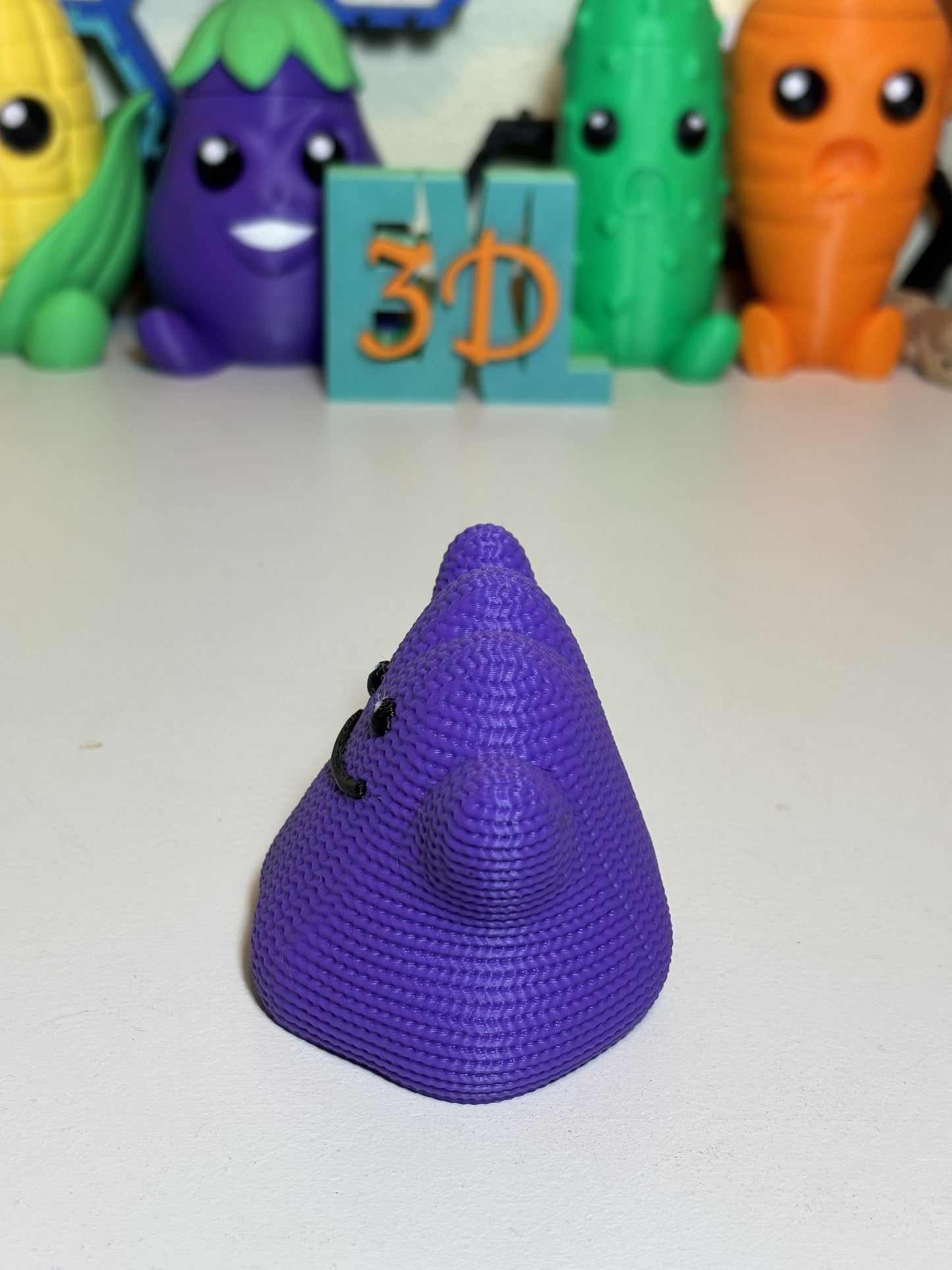 Faux knit Ditto sculpture sitting next to small gaming accessories on shelf
