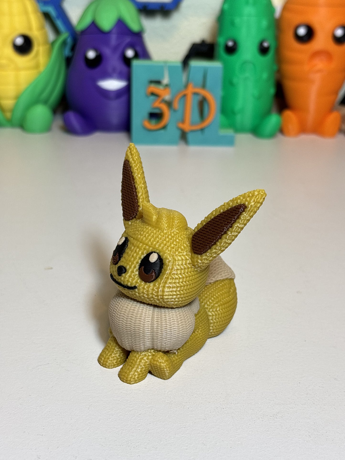 Faux knit 3D printed Eevee figure on wooden desk display