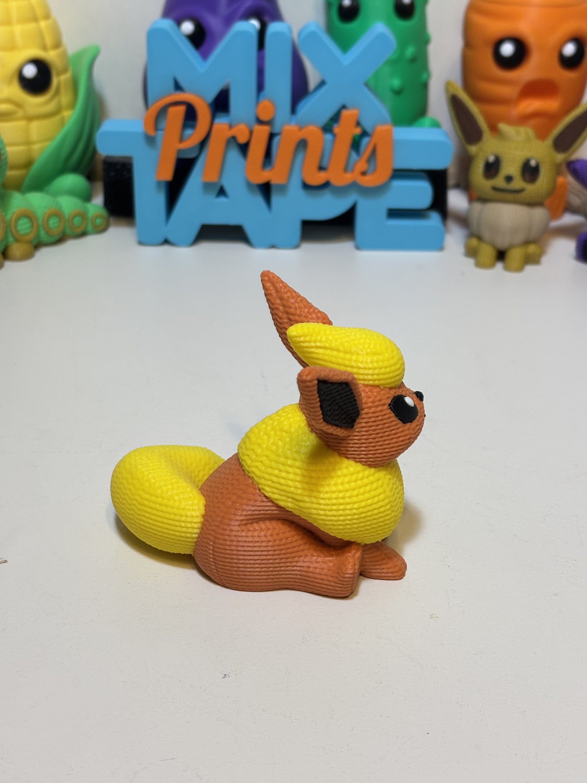 Side angle of faux knit Flareon figure showing matte textured finish