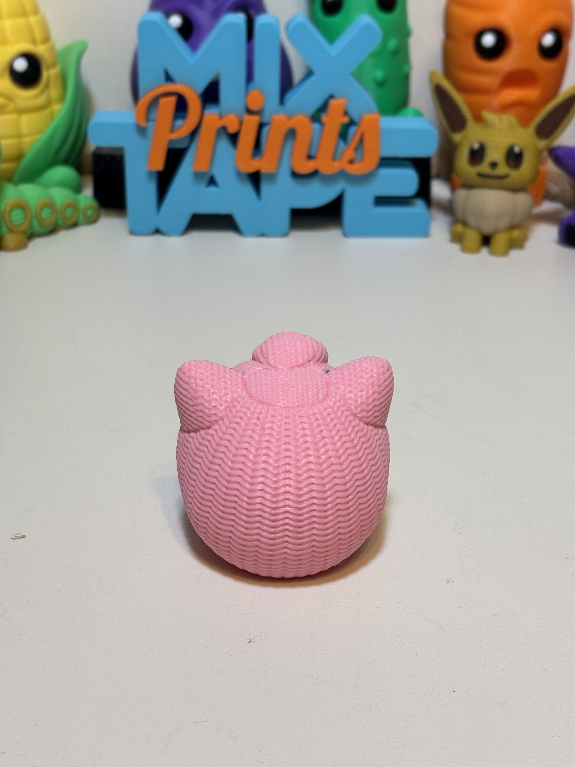 3D printed Jigglypuff gift figure styled on shelf with pop culture collectibles