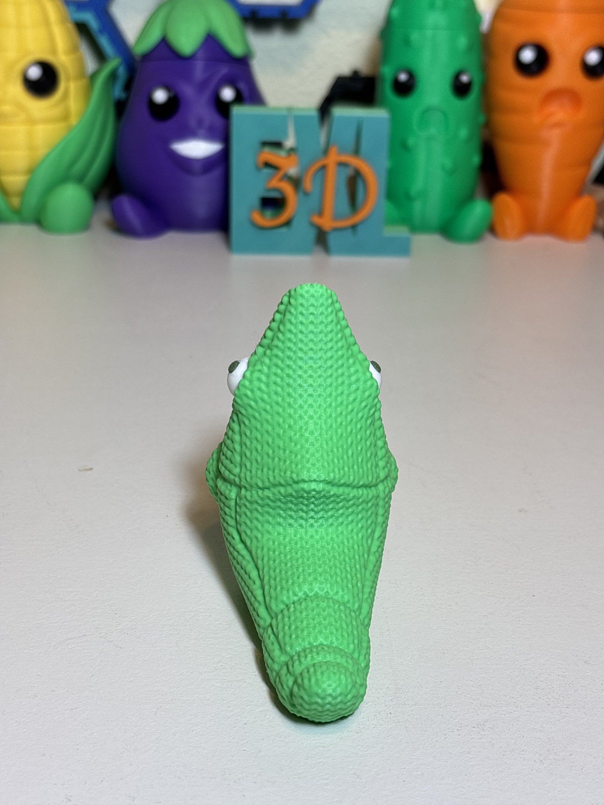 Faux knit Metapod figurine displayed as gamer desk decor accent piece