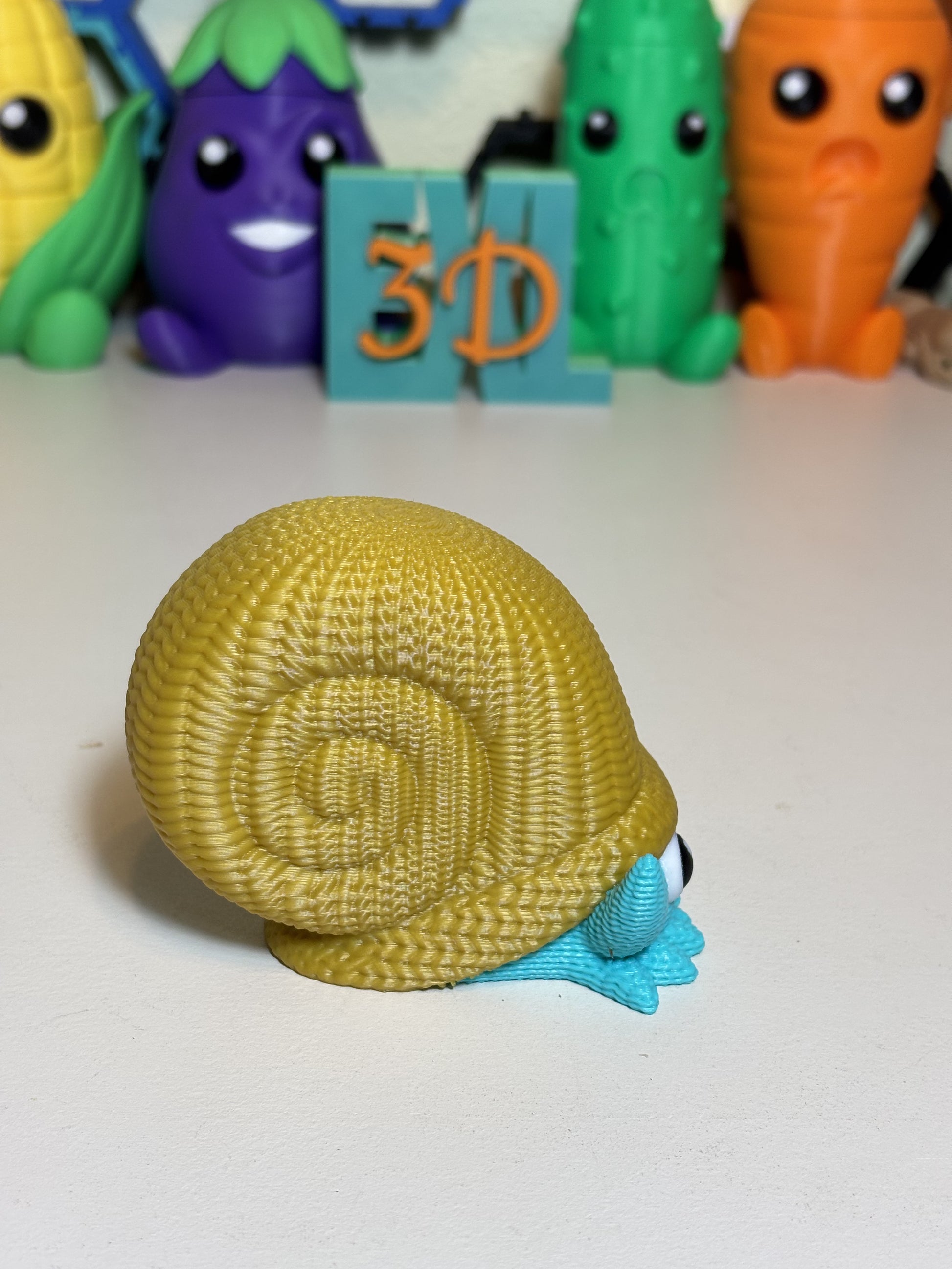 Faux knit Omanyte figurine beside plants as home desk decoration
